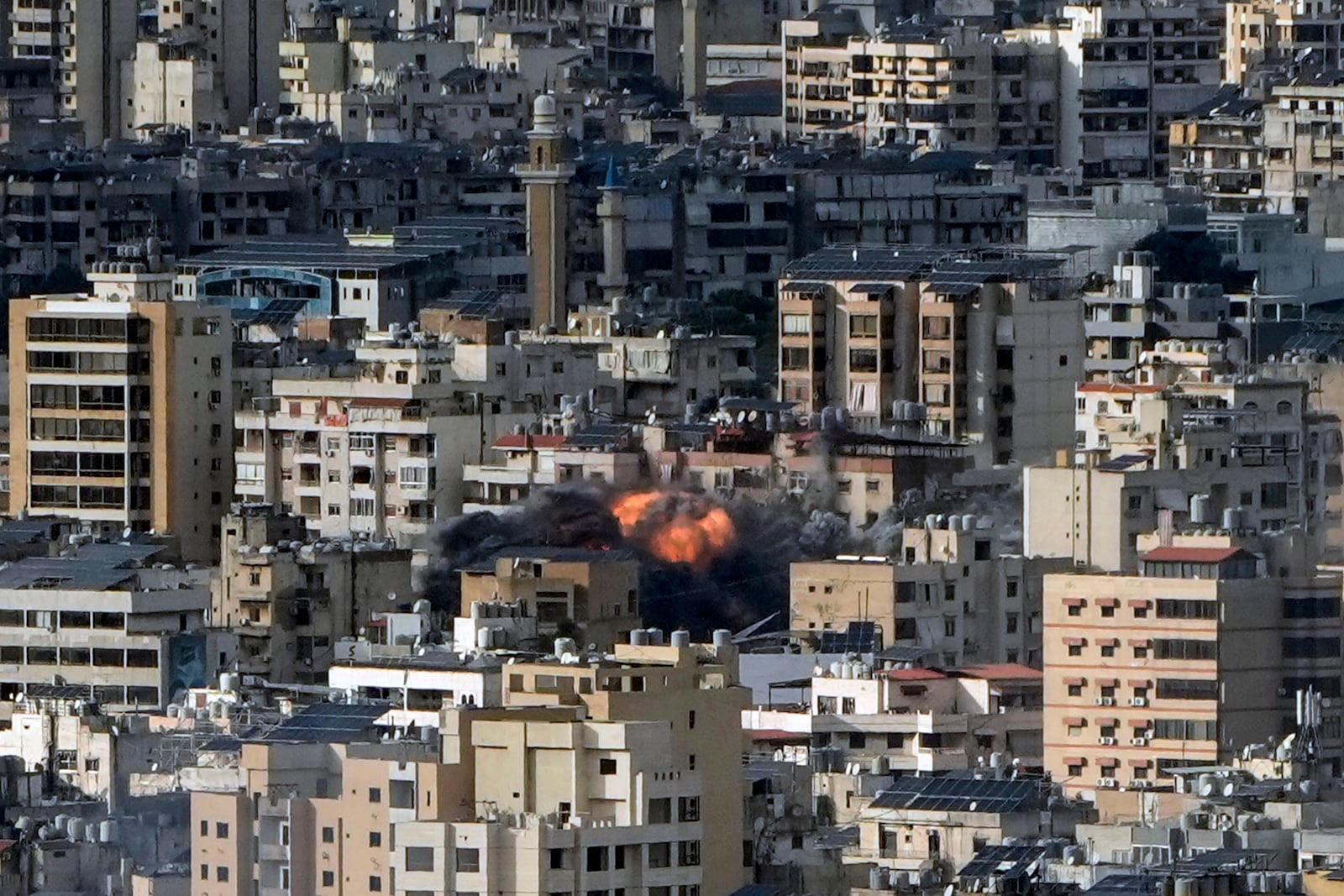 Smoke and flame rise after an Israeli airstrike on Dahiyeh, in Beirut, Lebanon, Monday, Nov. 25, 2024. (AP Photo/Bilal Hussein)