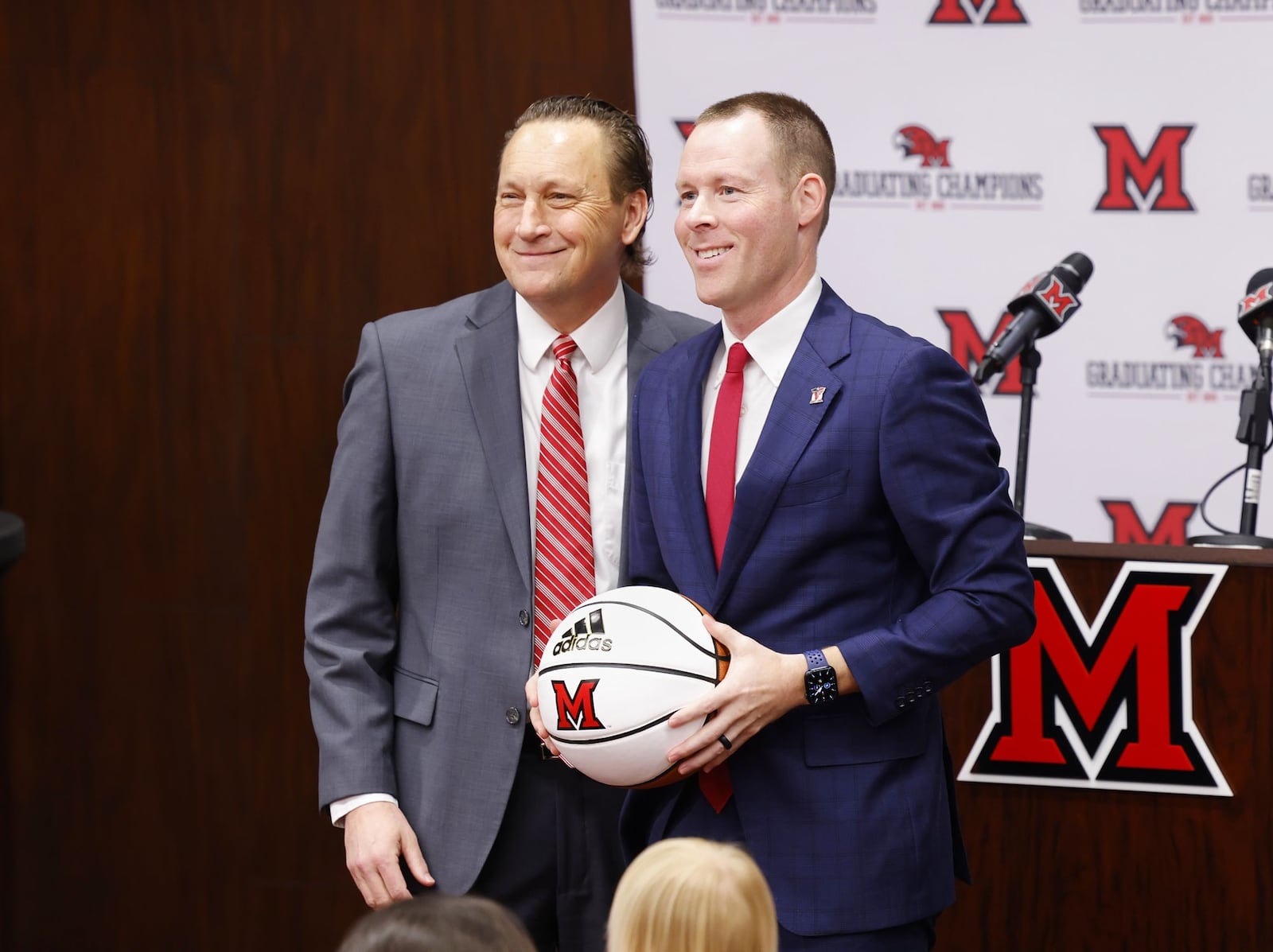 Miami University Director of Athletics David Sayler, left, stands with new Miami University Redhawks men's basketball coach Travis Steele during a press conference Friday, April 1, 2022 at the Randy Gunlock Family Athletic Center on the Miami University campus in Oxford. NICK GRAHAM/STAFF