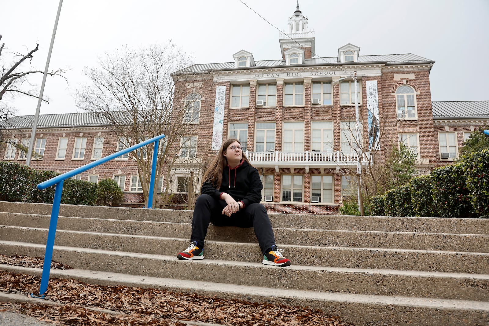 Glenn Thompson, a Durham School of the Arts graduate, poses in front of the school in Durham, N.C., Monday, March 10, 2025. (AP Photo/Karl DeBlaker)