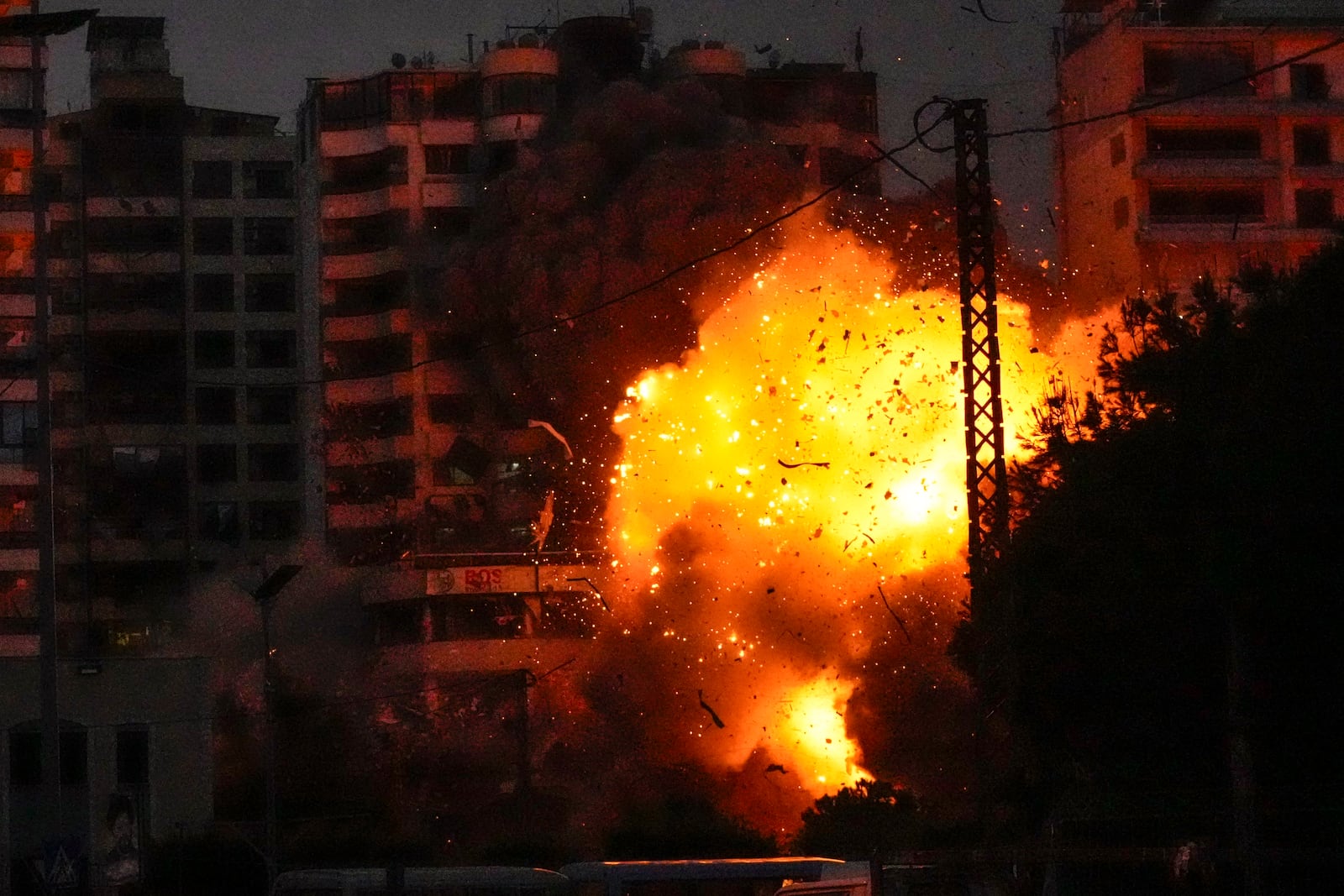 Thick smoke, flames and debris erupt from an Israeli airstrike that targeted a building in Tayouneh, Beirut, Lebanon, Monday, Nov. 25, 2024. (AP Photo/Hassan Ammar)