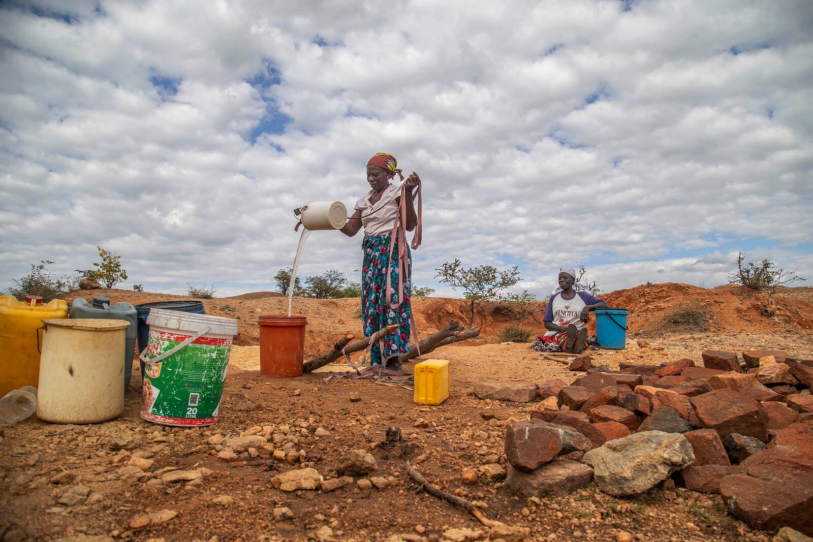 FILE - Villagers fetch water from a makeshift borehole in Mudzi, Zimbabwe, July 2, 2024. (AP Photo/Aaron Ufumeli, File)