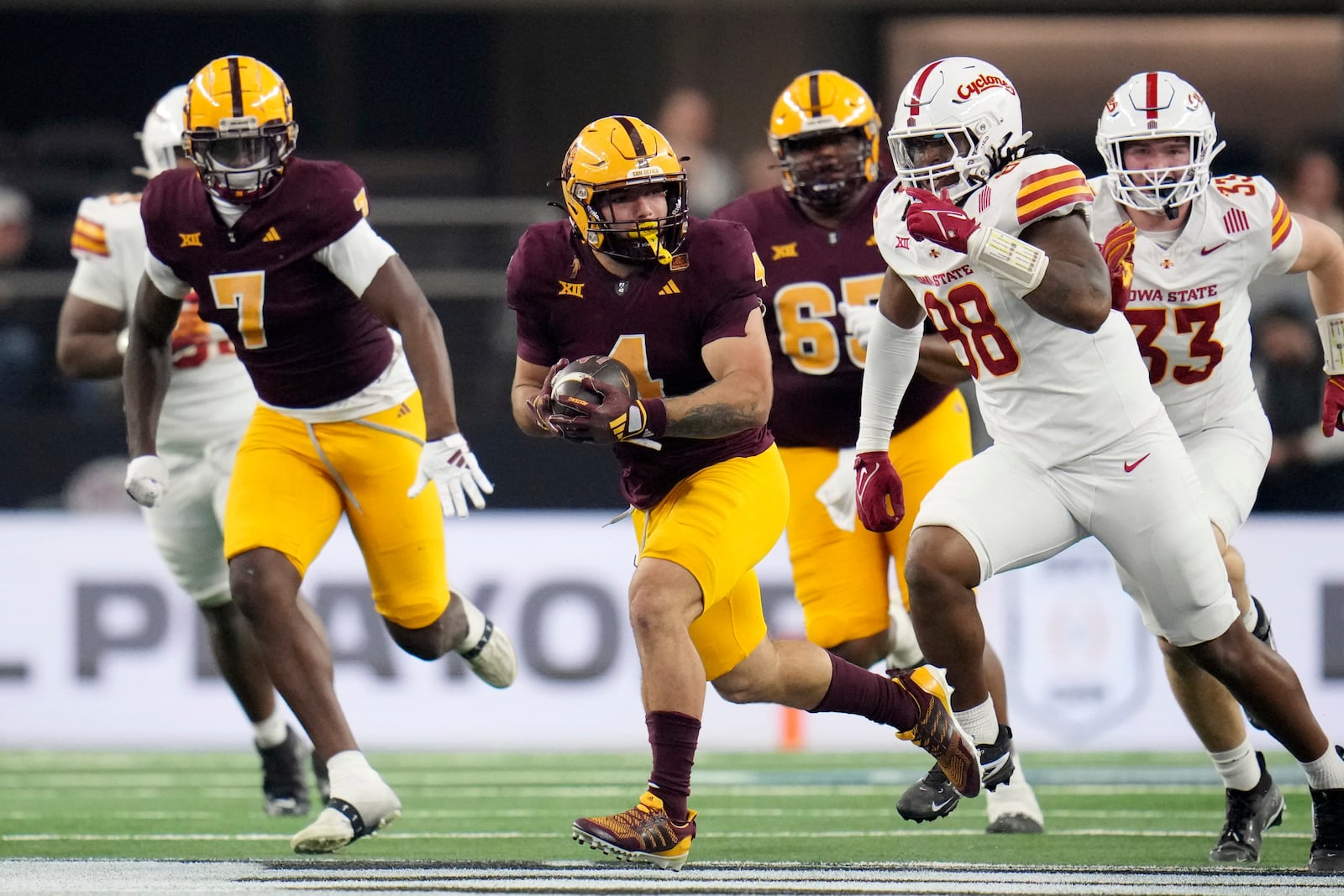 Arizona State running back Cam Skattebo (4) carries the ball for a long gain after getting past Iowa State defensive end Ikenna Ezeogu (88) in the first half of the Big 12 Conference championship NCAA college football game, in Arlington, Texas, Saturday Dec. 7, 2024. (AP Photo/Julio Cortez)