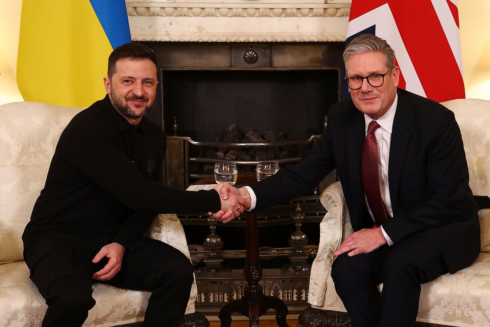 Britain's Prime Minister Keir Starmer, right, and Ukraine's President Volodymyr Zelenskyy, left, shake hands during a meeting at 10 Downing Street in London, England, Saturday, March 1, 2025. (Peter Nicholls/Pool Photo via AP)