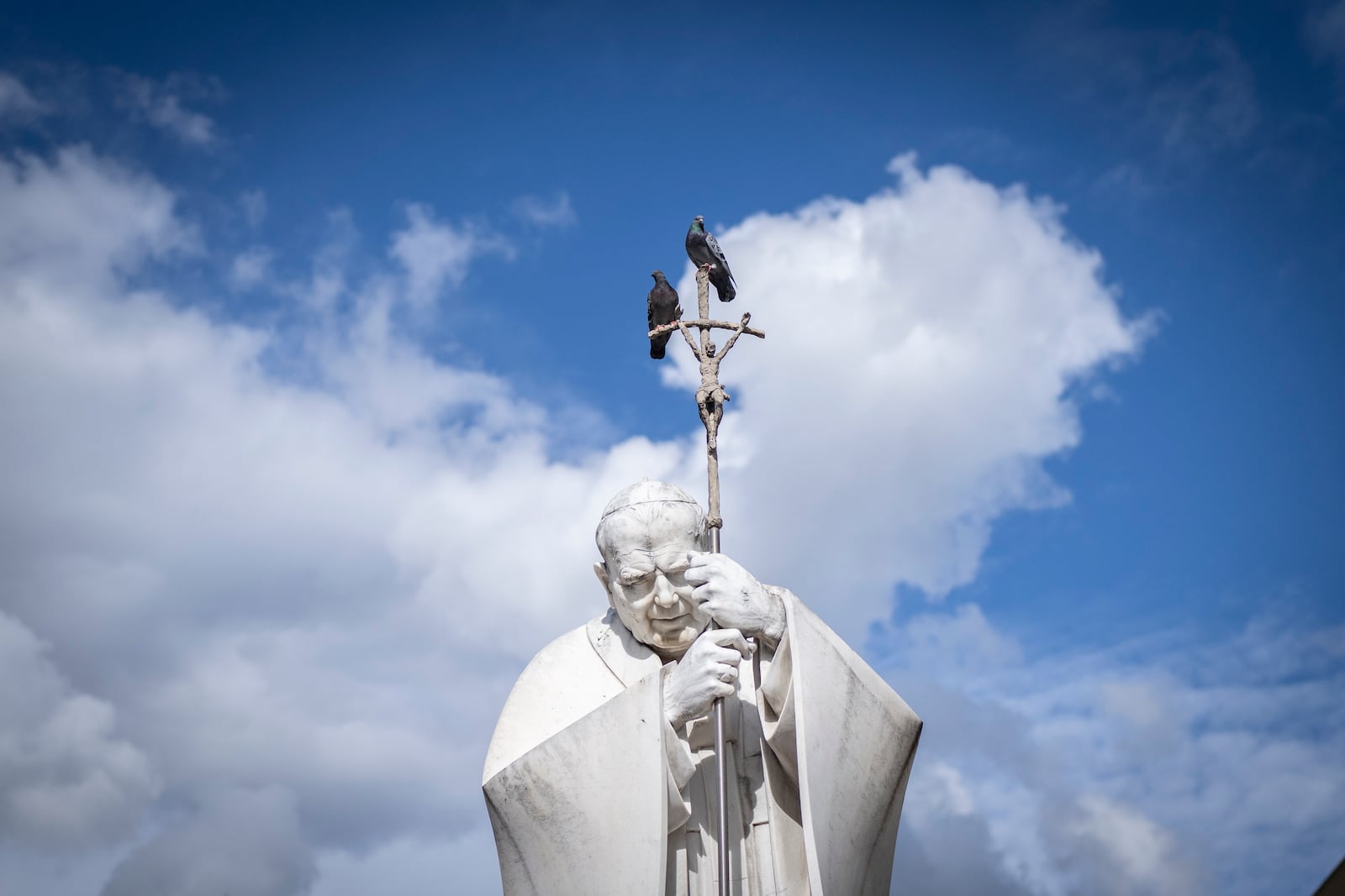 Pigeons on a statue of Pope John Paul II outside the Agostino Gemelli Polyclinic, in Rome, Friday, Feb. 28, 2025 where Pope Francis has been hospitalized since Friday, Feb. 14. (AP Photo/Mosa'ab Elshamy)