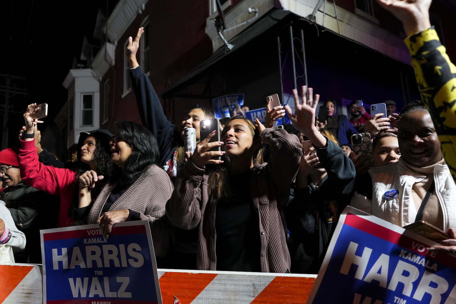 Kamala Harris supporters cheer as New York Rep. Alexandria Ocasio-Cortez walks out of a Puerto Rican restaurant that she visited with presidential candidate Kamala Harris in Reading, Pa., Monday, Nov. 4, 2024. (AP Photo/Luis Andres Henao)