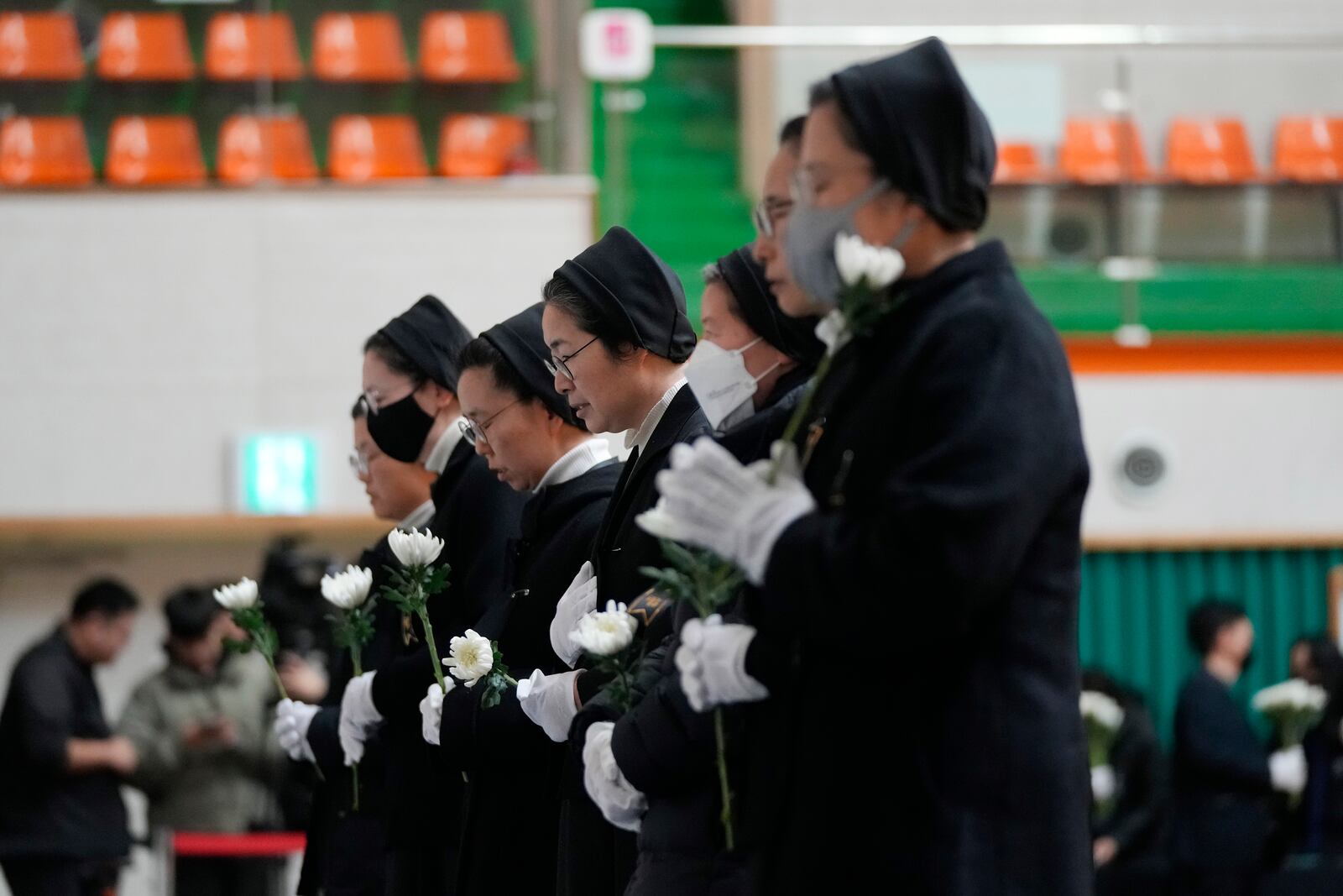 Nuns pray for the victims of a plane fire at a memorial altar at Muan sport park in Muan, South Korea, Monday, Dec. 30, 2024. (AP Photo/Ahn Young-joon)