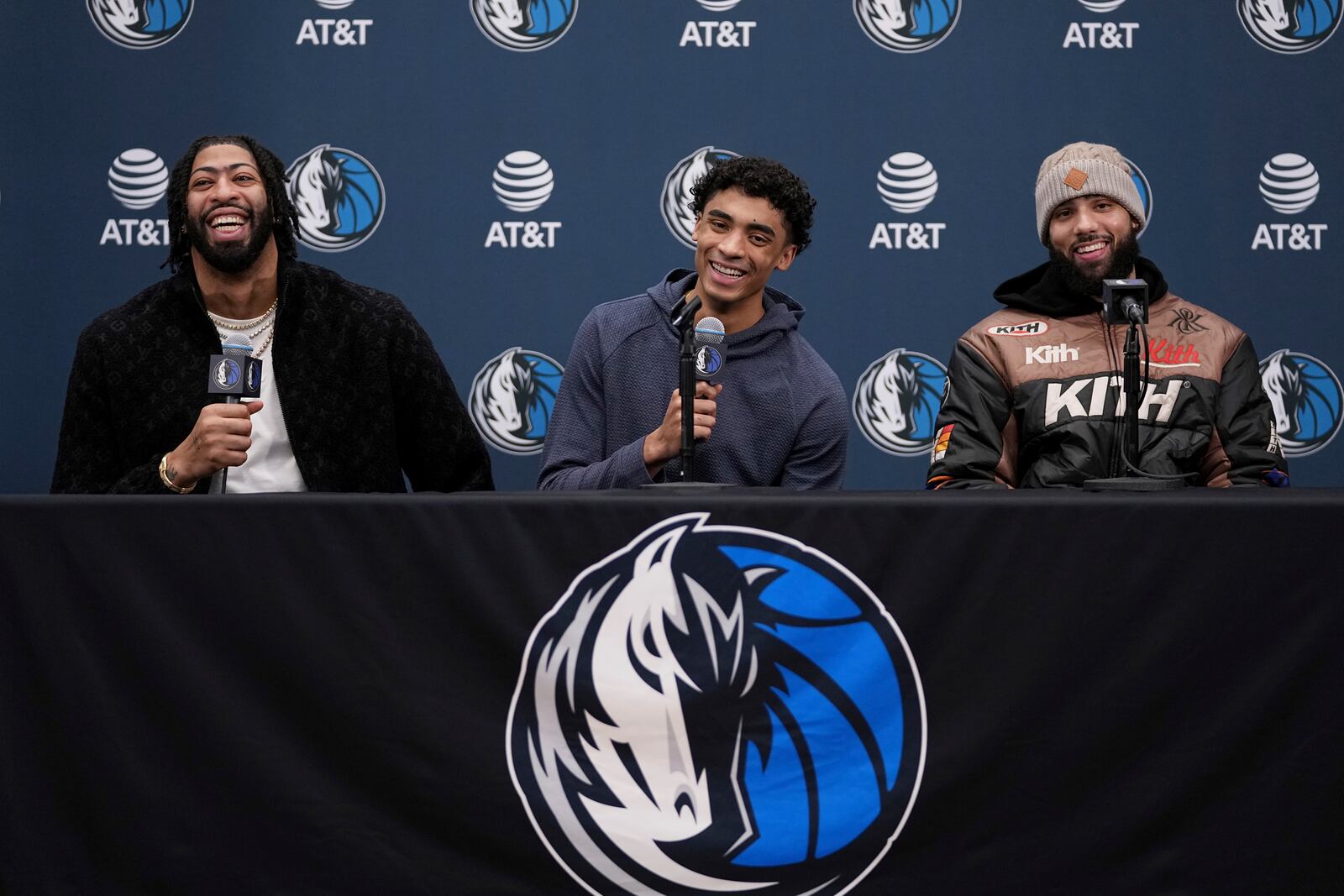 Newly acquired Dallas Mavericks players Anthony Davis, left, Max Christie, center, and Caleb Martin, right, laugh as they respond to a question during an NBA basketball news conference at the team's practice facility in Dallas, Friday, Feb. 7, 2025. (AP Photo/Tony Gutierrez)