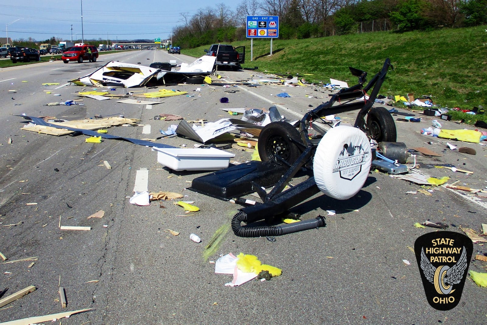 Debris from a trailer is strewn across Interstate 71 after a pickup truck was struck and overturned, causing its trailer to detach April 22, 2022, in Deerfield Twp. CONTRIBUTED