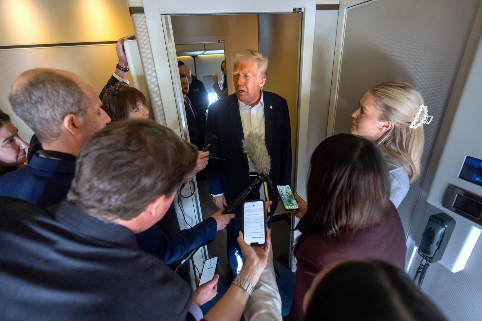 President Donald Trump speaks to reporters aboard Air Force One as he travels from Las Vegas to Miami on Saturday, Jan. 25, 2025. (AP Photo/Mark Schiefelbein)