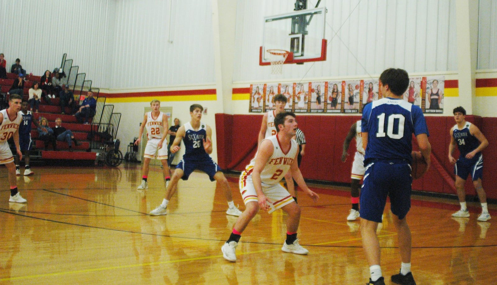 Fenwick’s Jared Morris (2) keeps a close eye on St. Xavier’s Nathan Stockman (10) during Saturday night’s game at Fenwick. The host Falcons won 58-53. RICK CASSANO/STAFF