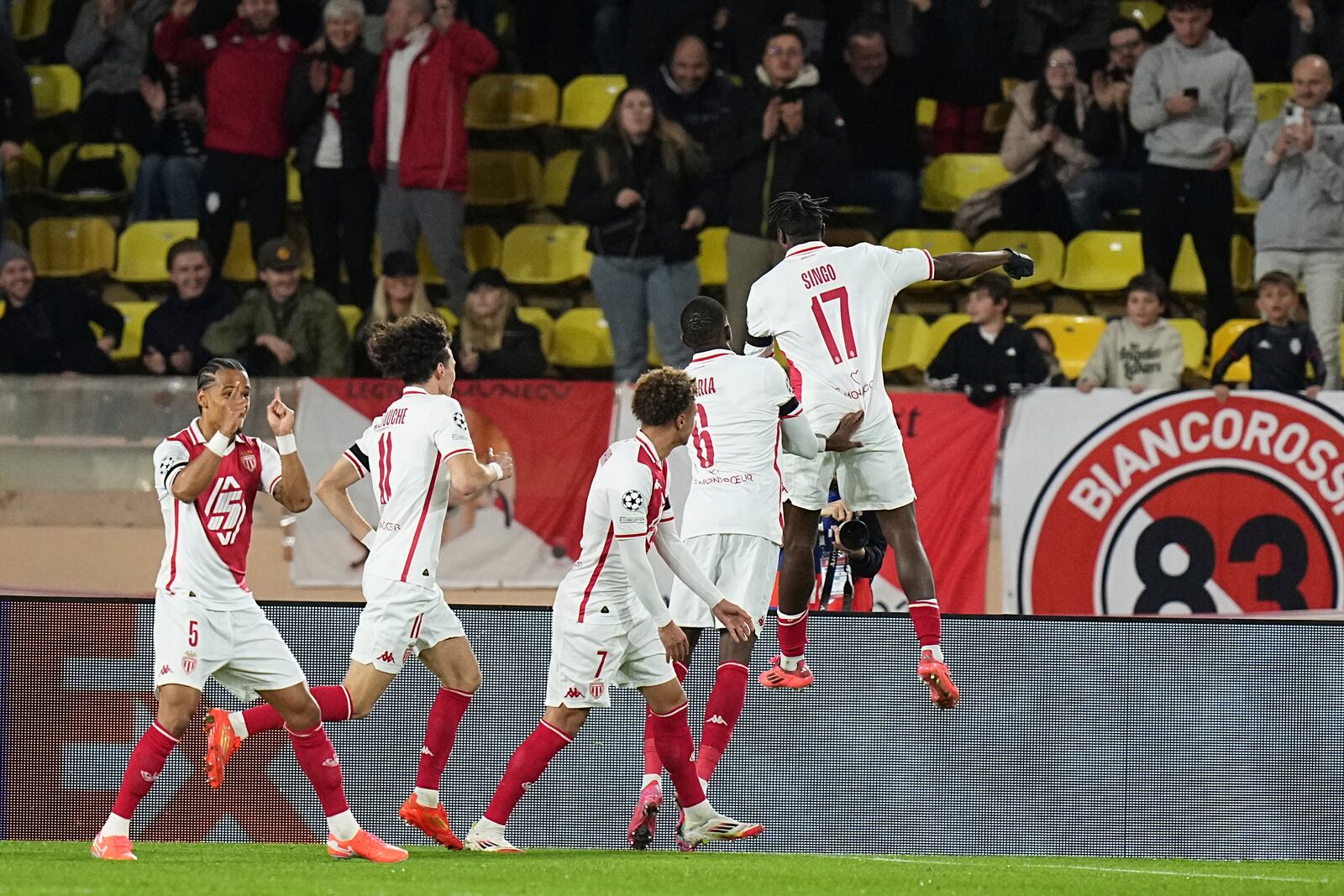 Monaco's Wilfried Singo, right, celebrates after scoring the opening goal of his team during a Champions League opening phase soccer match between Monaco and Aston Villa at the Louis II stadium in Monaco, Tuesday, Jan. 21, 2025. (AP Photo/Laurent Cipriani)