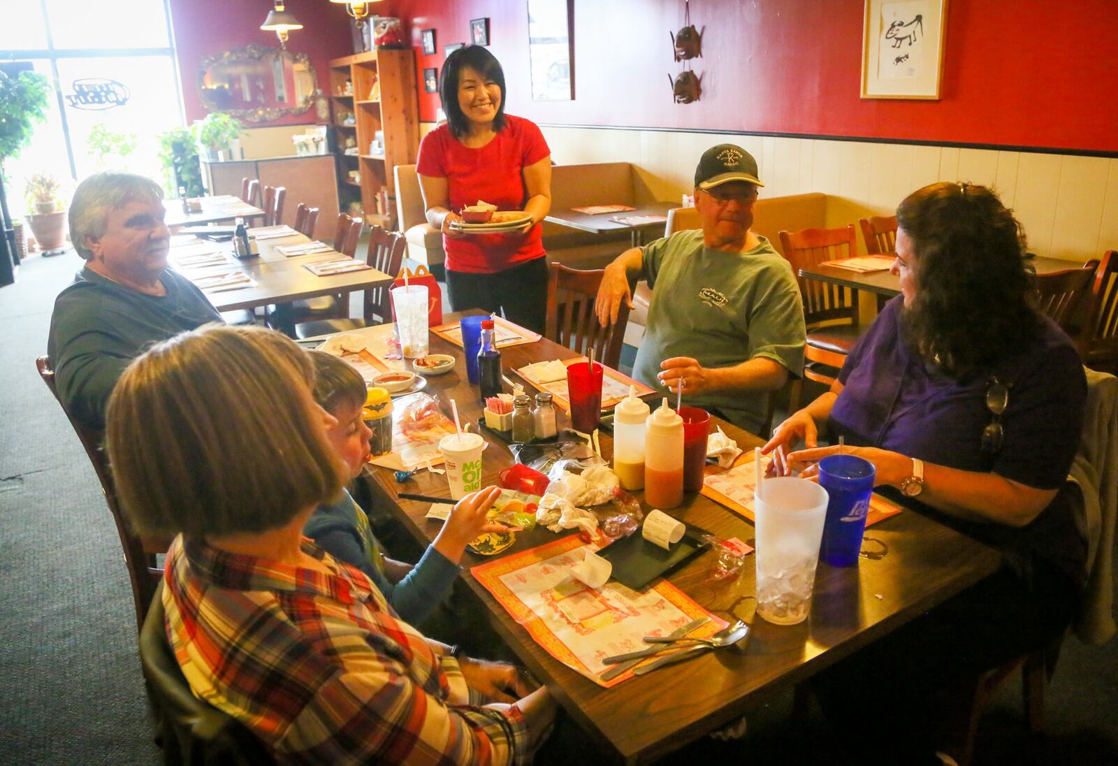 Heek Hake, daughter of Moon Garden restaurant owners John and Sue Chun, talks with customers in the restaurant, Thursday, Feb. 23, 2017. Moon Garden is closing Feb. 28 after 37 years in business. GREG LYNCH / STAFF