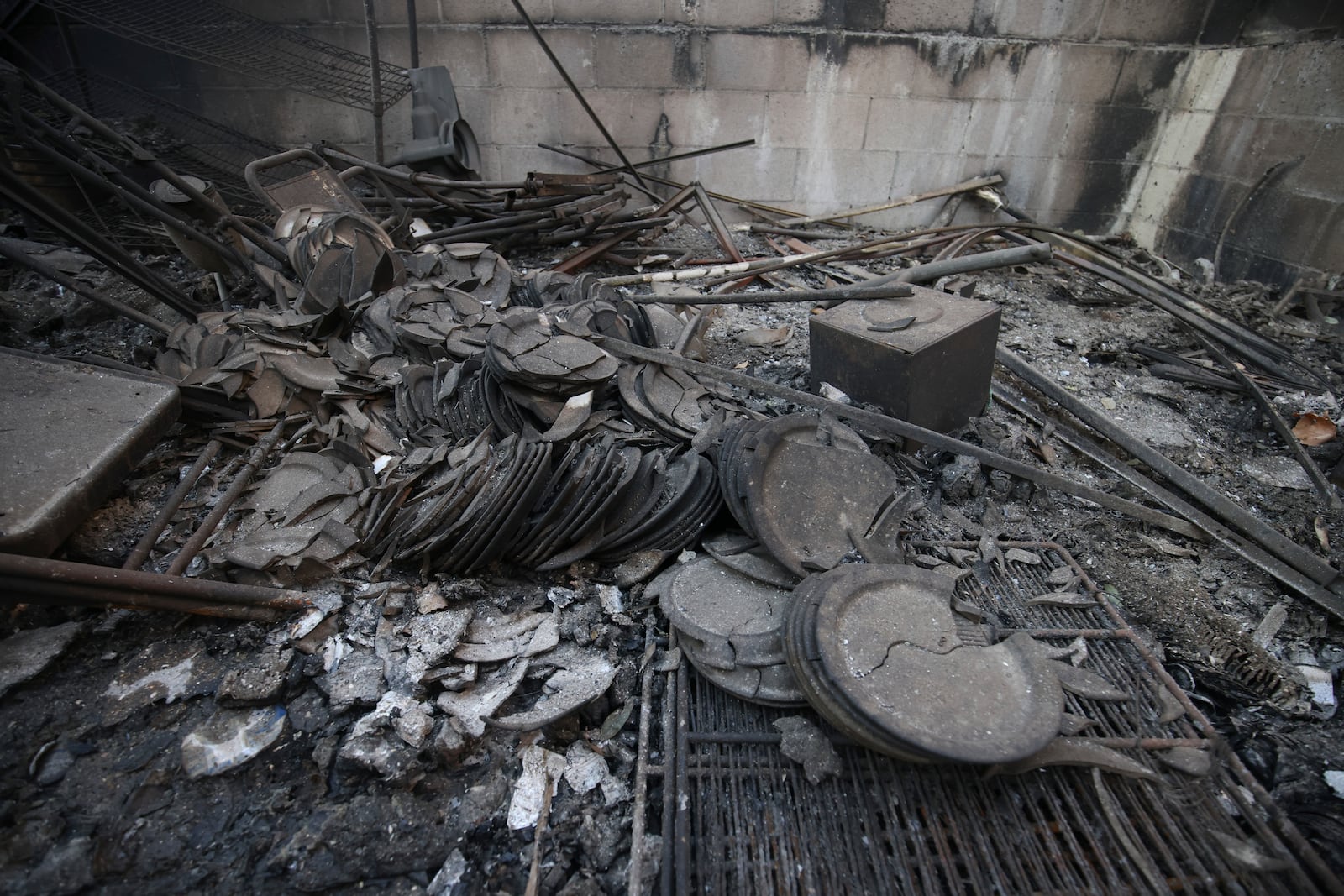 Dishes destroyed by the Eaton Fire lie on the ground on Sunday, Jan. 12, 2025, in Altadena, Calif. (AP Photo/Ethan Swope)