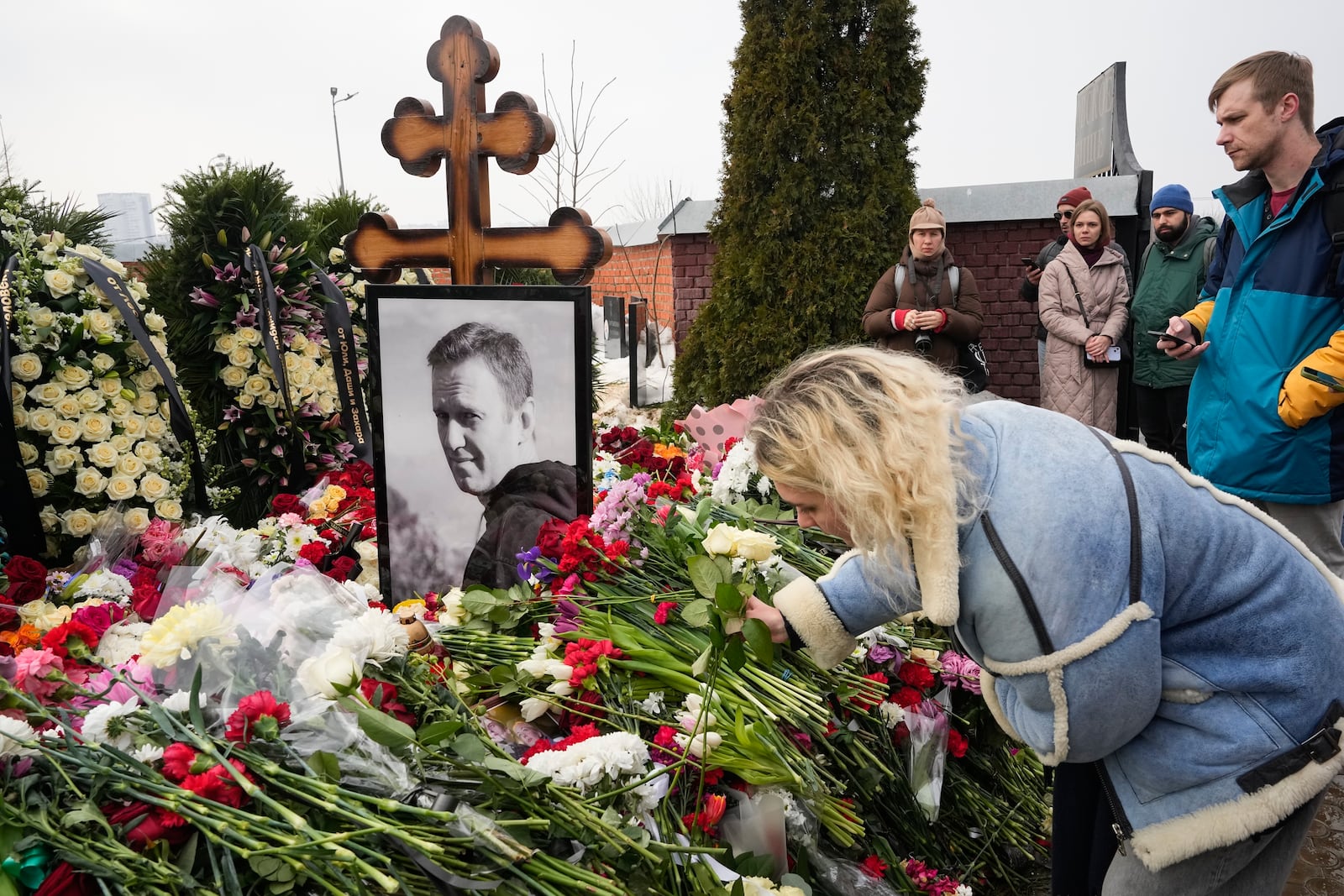 FILE - A woman lays flowers at the grave of Russian opposition leader Alexei Navalny at the Borisovskoye Cemetery in Moscow, on March 2, 2024. (AP Photo, File)