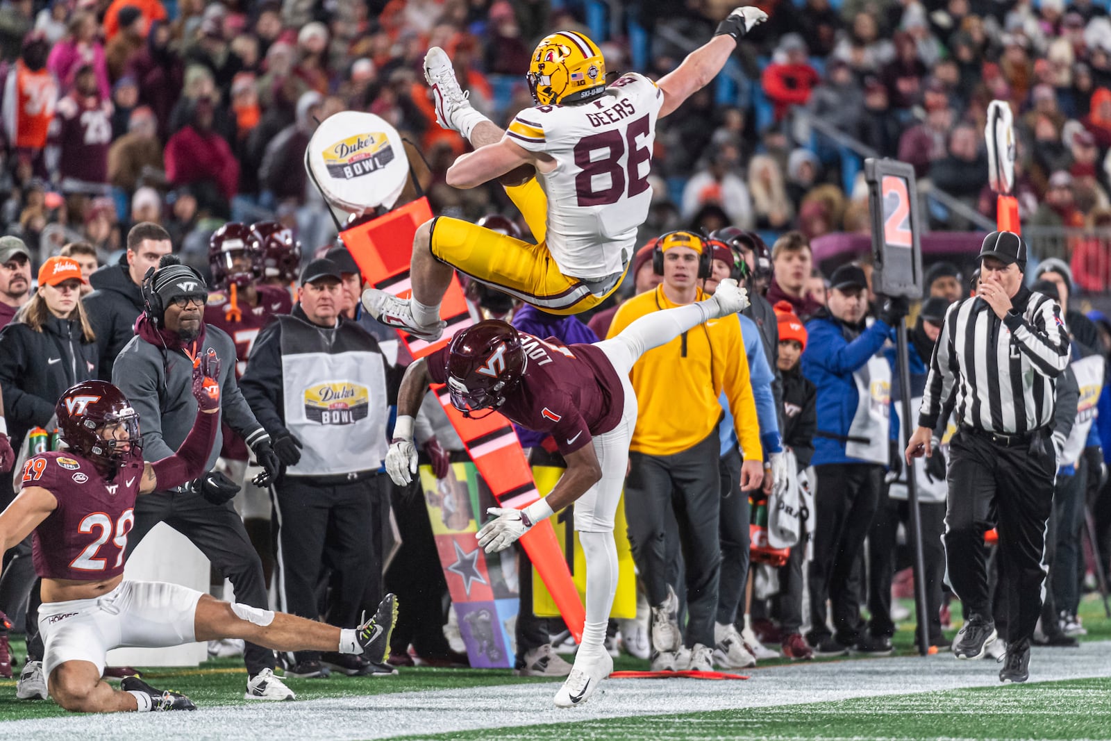 Minnesota tight end Jameson Geers (86) goes over Virginia Tech cornerback Dante Lovett (1) during the first half of the Duke's Mayo Bowl NCAA college football game Friday, Jan. 3, 2025, in Blacksburg, Va. (AP Photo/Robert Simmons)