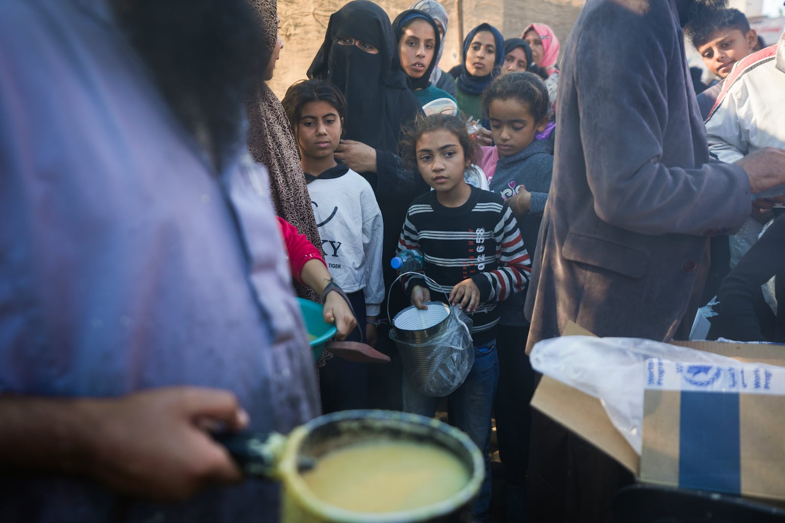 Palestinians queue for food in Deir al-Balah, Gaza Strip, Monday, Nov. 18, 2024. (AP Photo/Abdel Kareem Hana)