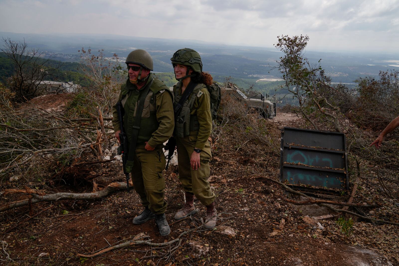 Israeli soldiers display what they say is an entrance to a Hezbollah tunnel found during their ground operation in southern Lebanon, near the border with Israel, Sunday, Oct. 13, 2024. (AP Photo/Sam McNeil)