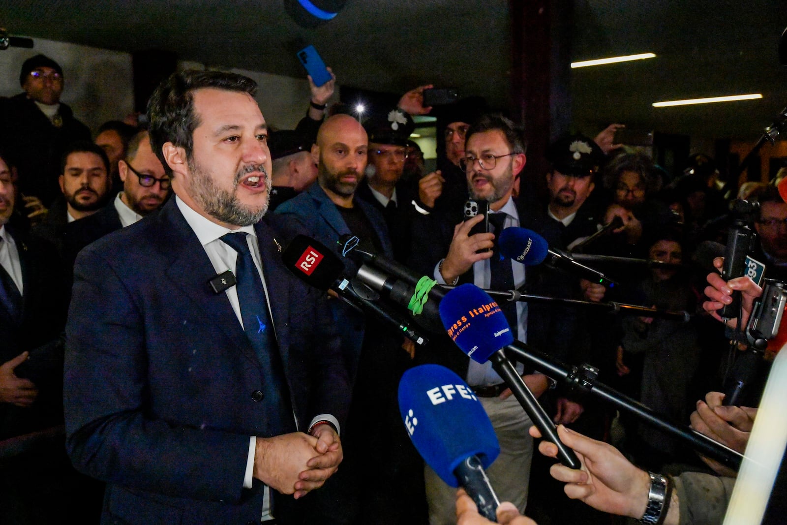 Italy's vice Premier Matteo Salvini speaks to journalists as he leaves a Palermo's law court in Sicily, Italy, Friday, Dec. 20, 2024, after he was acquitted in a first instance trial where he was accused of blocking for 19 days the disembarkation of 147 people, including minors, rescued at sea by the NGO Open Arms in August 2019.(AP Photo/Salvatore Cavalli)