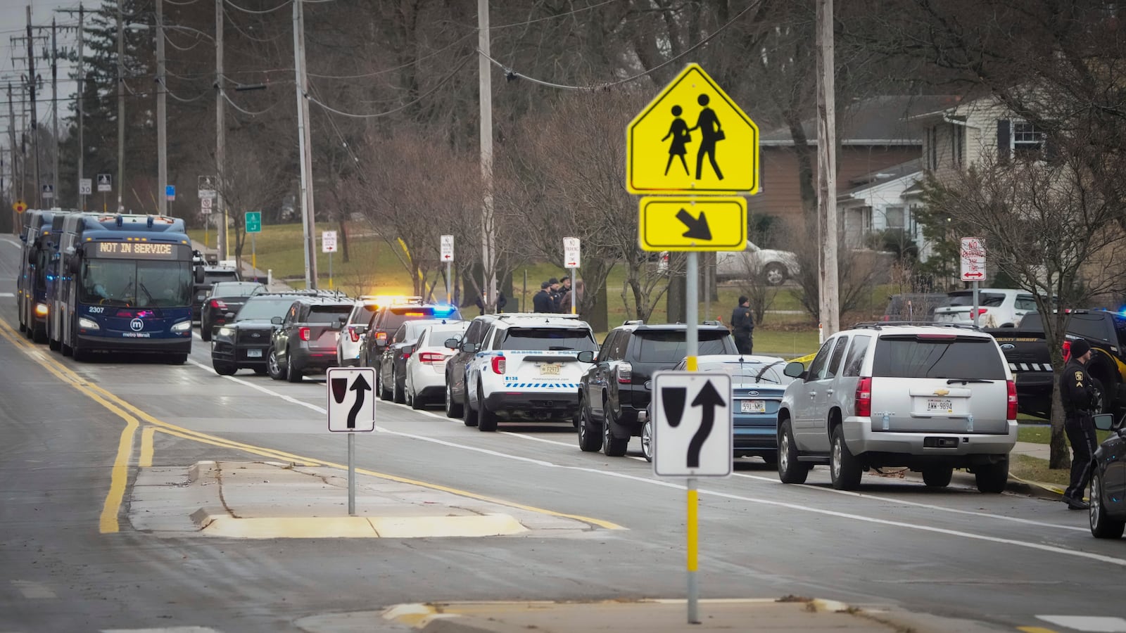 Emergency vehicles are staged outside the Abundant Life Christian School in Madison, Wis., where multiple injuries were reported following a shooting, Monday, Dec. 16, 2024. (AP Photo/Morry Gash)