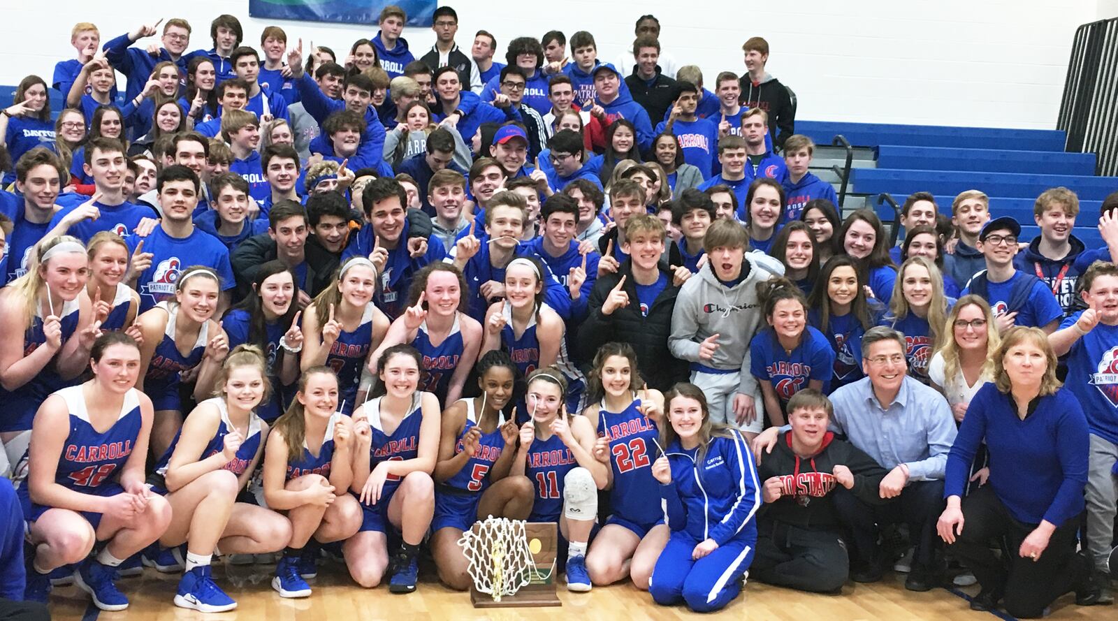 The Carroll girls basketball team celebrates with its fans Friday night after defeating Franklin 57-43 to win a Division II regional championship at Springfield. RICK CASSANO/STAFF