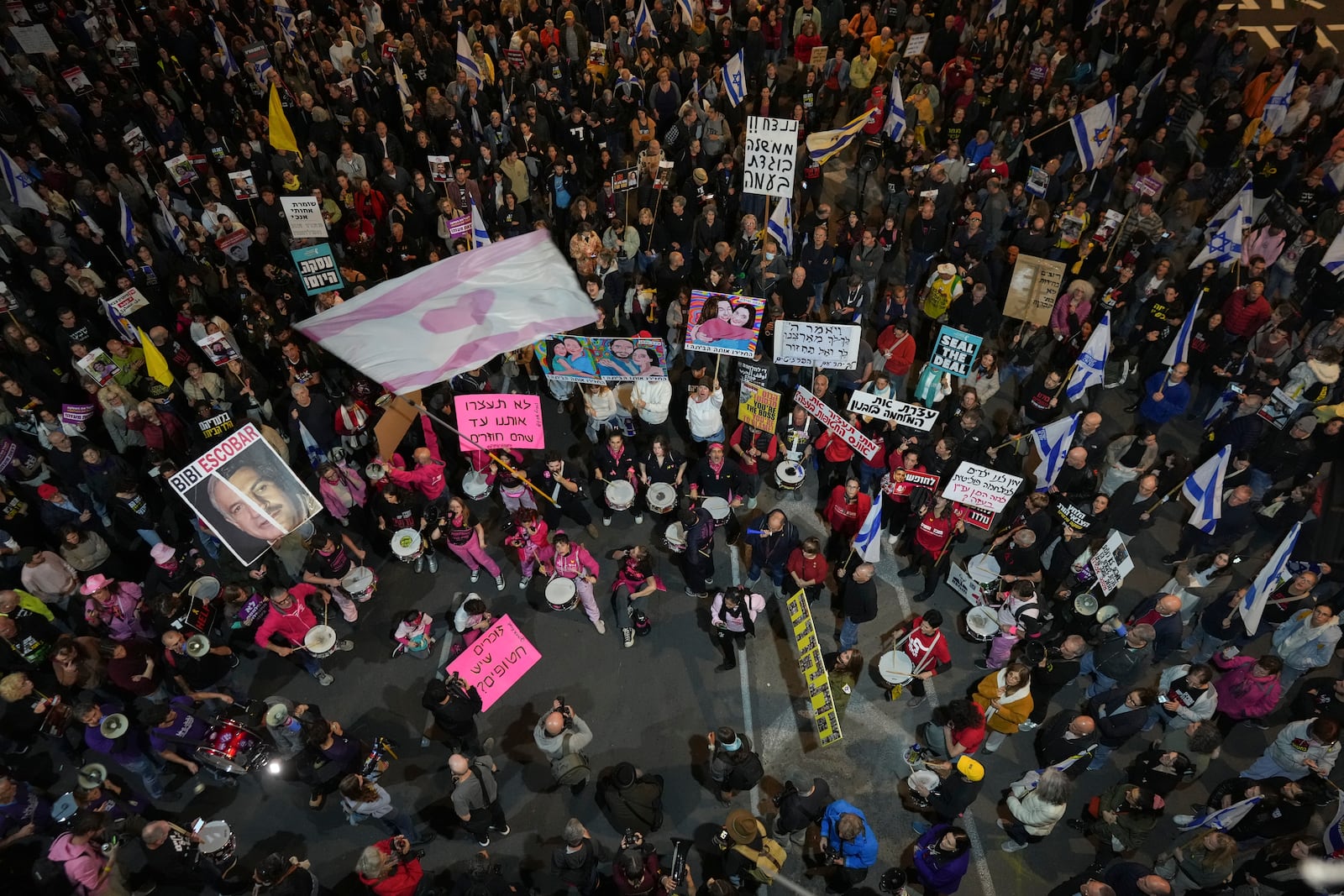 People shout slogans during a protest against Prime Minister Benjamin Netanyahu's government and call for the release of hostages held in the Gaza Strip by the Hamas militant group, in Tel Aviv, Israel, Saturday Nov. 30, 2024.(AP Photo/Ohad Zwigenberg)