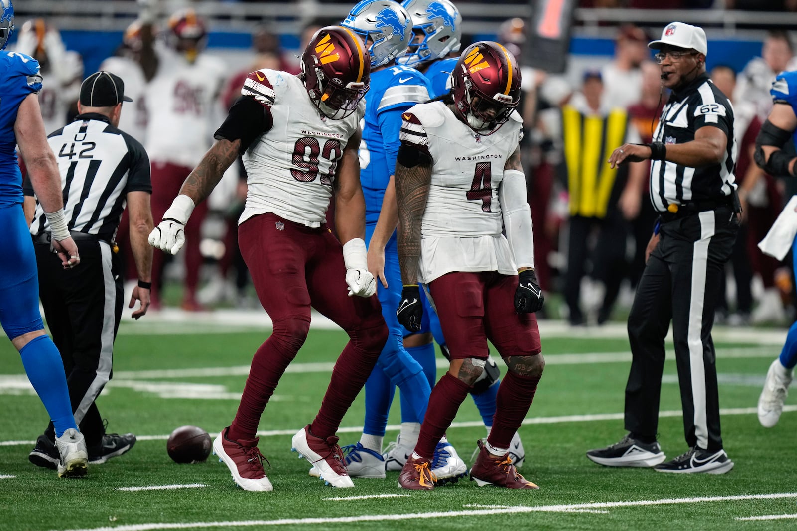 Washington Commanders defensive end Dorance Armstrong (92) and Frankie Luvu (4) celebrate a sack on Detroit Lions quarterback Jared Goff during the second half of an NFL football divisional playoff game, Saturday, Jan. 18, 2025, in Detroit. (AP Photo/Seth Wenig)