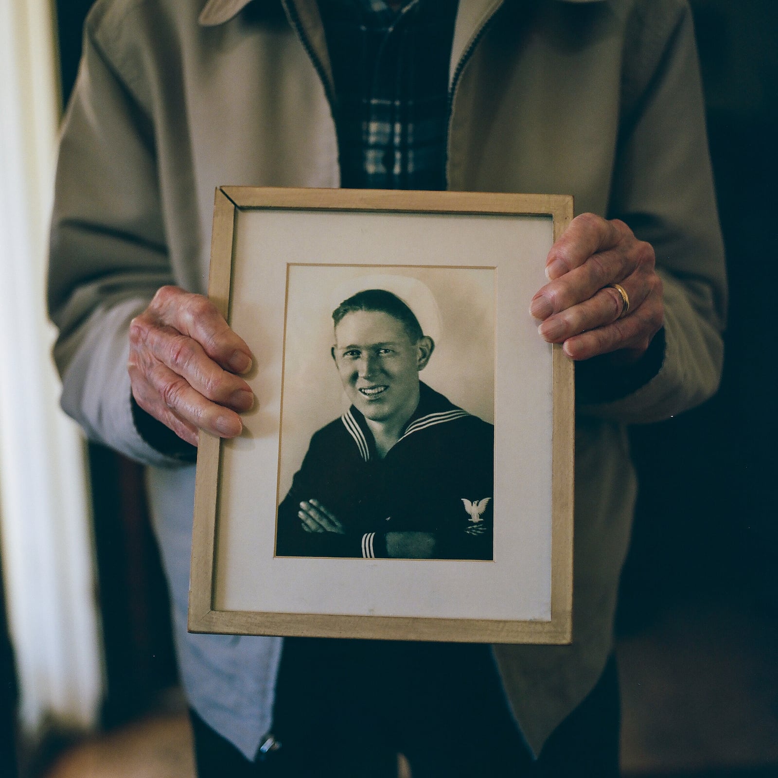 Warren Upton holds a portrait at his home in San Jose, Calif., on Friday, Nov. 26, 2021. (Shae Hammond/Bay Area News Group via AP)