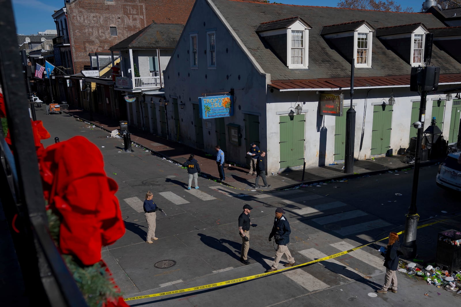 Members of the FBI walk around Bourbon Street during the investigation of a truck fatally crashing into pedestrians on Bourbon Street in the French Quarter in New Orleans, Wednesday, Jan. 1, 2025. (AP Photo/Matthew Hinton)