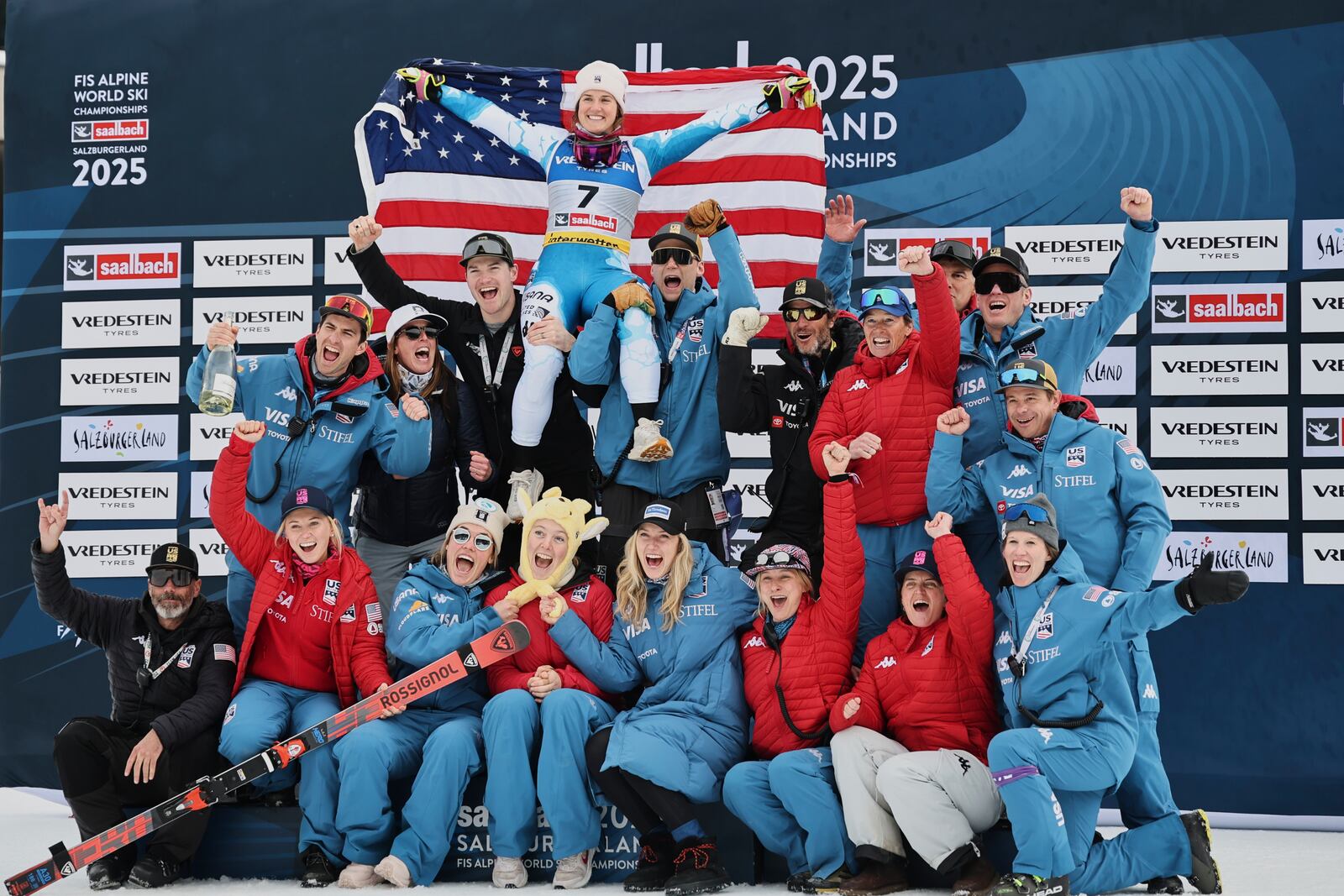 United States' Paula Moltzan, top, celebrates with the team after winning the bronze medal in a women's giant slalom, at the Alpine Ski World Championships, in Saalbach-Hinterglemm, Austria, Thursday, Feb. 13, 2025. (AP Photo/Marco Trovati)