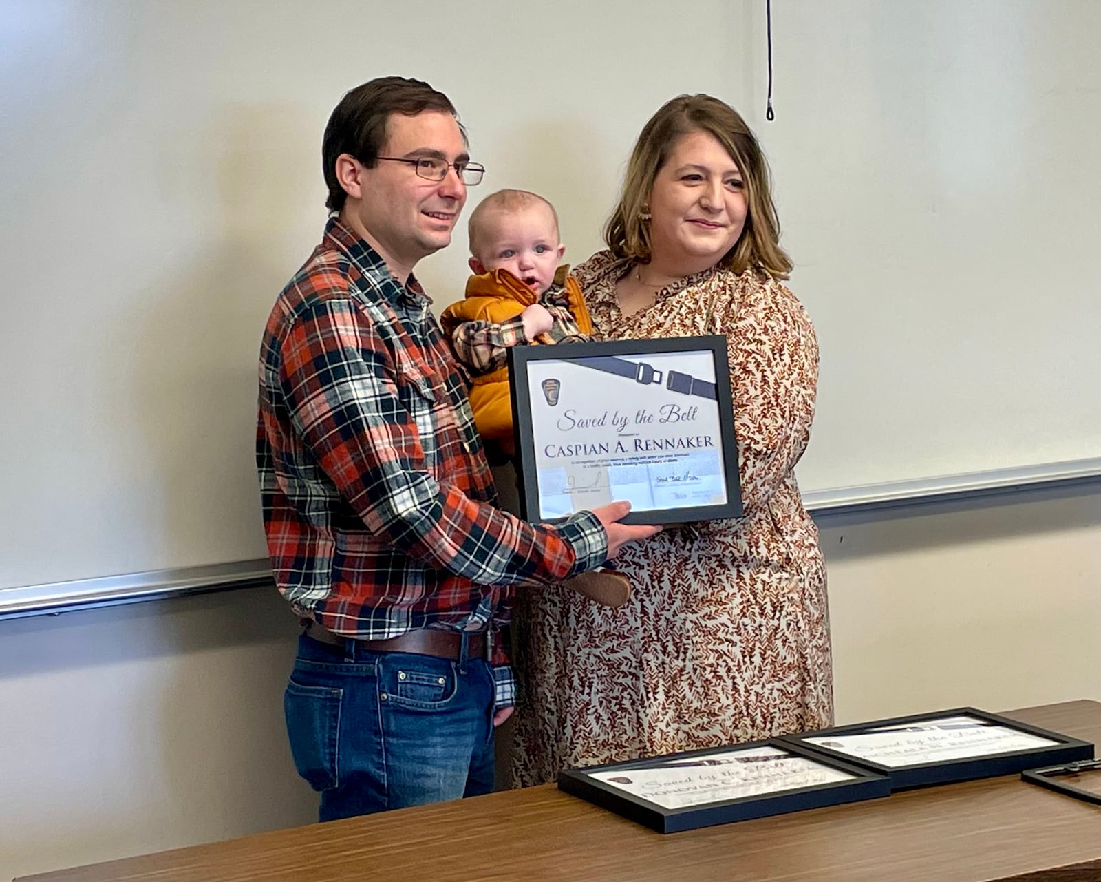 Micheala and Donovan Rennaker, and their son Caspian, survived what could have been a deadly car crash in February thanks to the use of safety belts and a properly secured infant car seat. The family was honored Saturday with the Ohio Department of Public Safety's "Saved by the Belt" award.