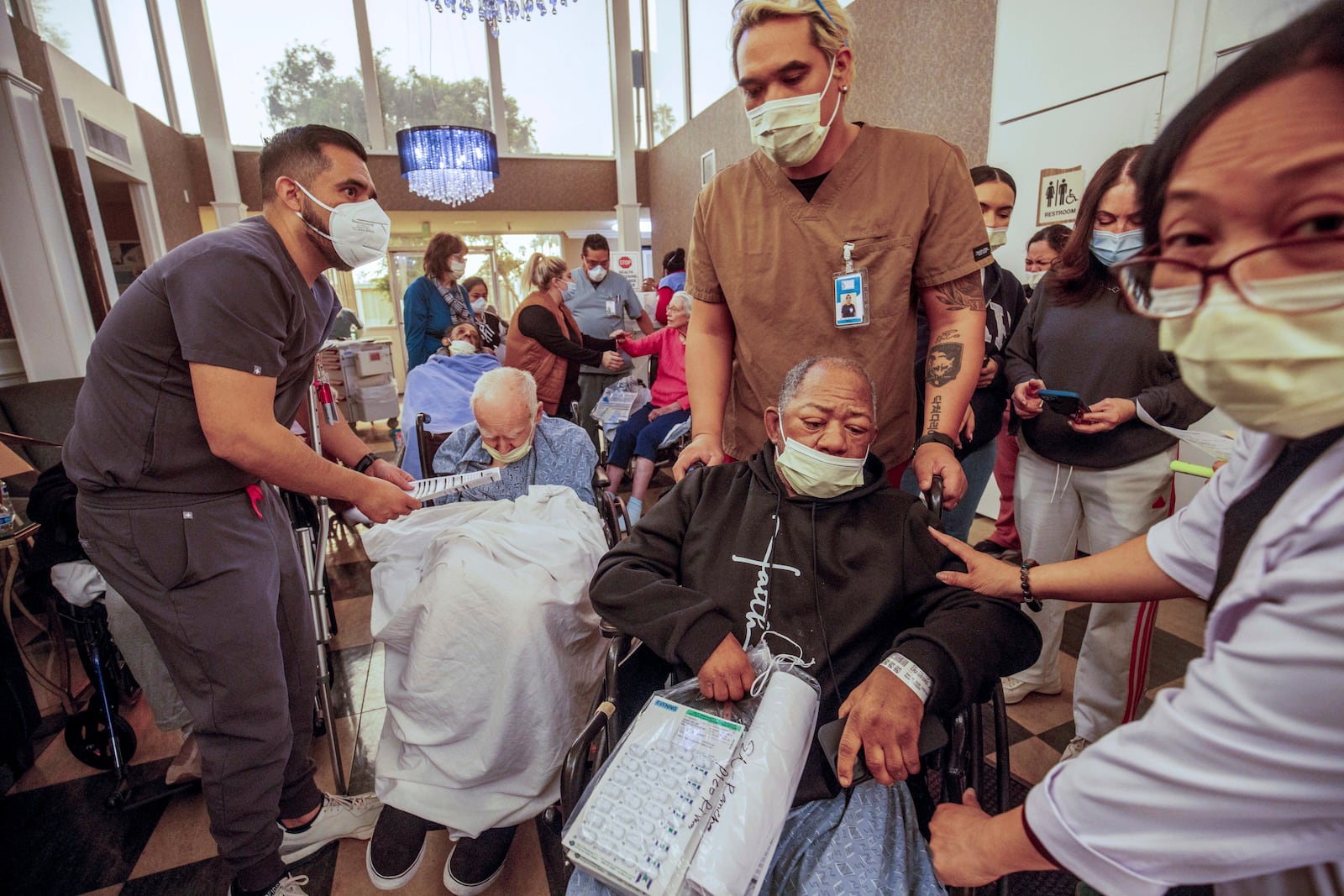 Residents are evacuated from a senior living facility as the Eaton Fire approaches Wednesday, Jan. 8, 2025 in Altadena, Calif. (AP Photo/Ethan Swope)