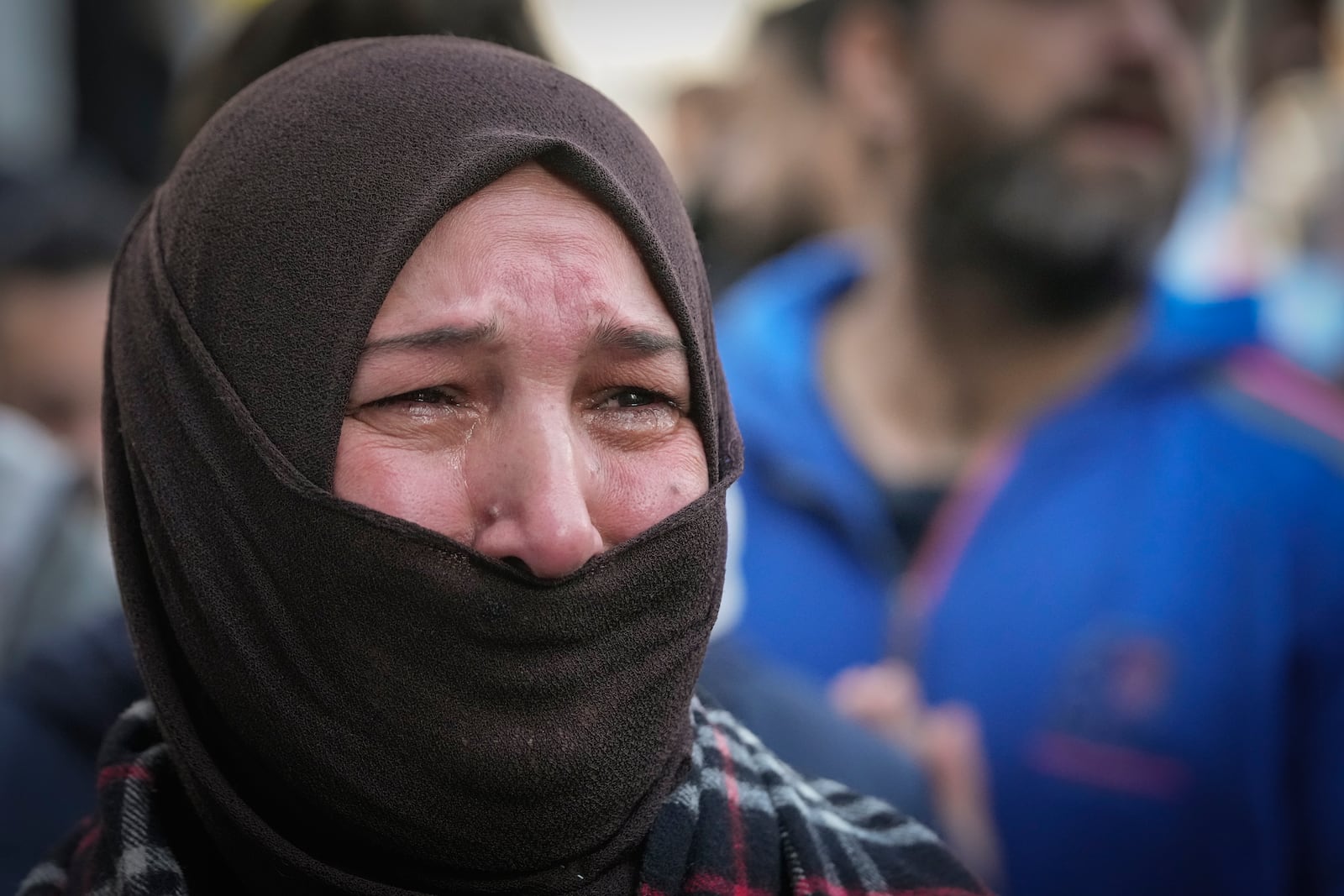 A woman cries during the funeral of Syrian activist Mazen al-Hamada in Damascus Thursday Dec. 12, 2024. Al-Hamad's mangled corpse was found wrapped in a bloody sheet in Saydnaya prison. He had fled to Europe but returned to Syria in 2020 and was imprisoned upon arrival. (AP Photo/Hussein Malla)