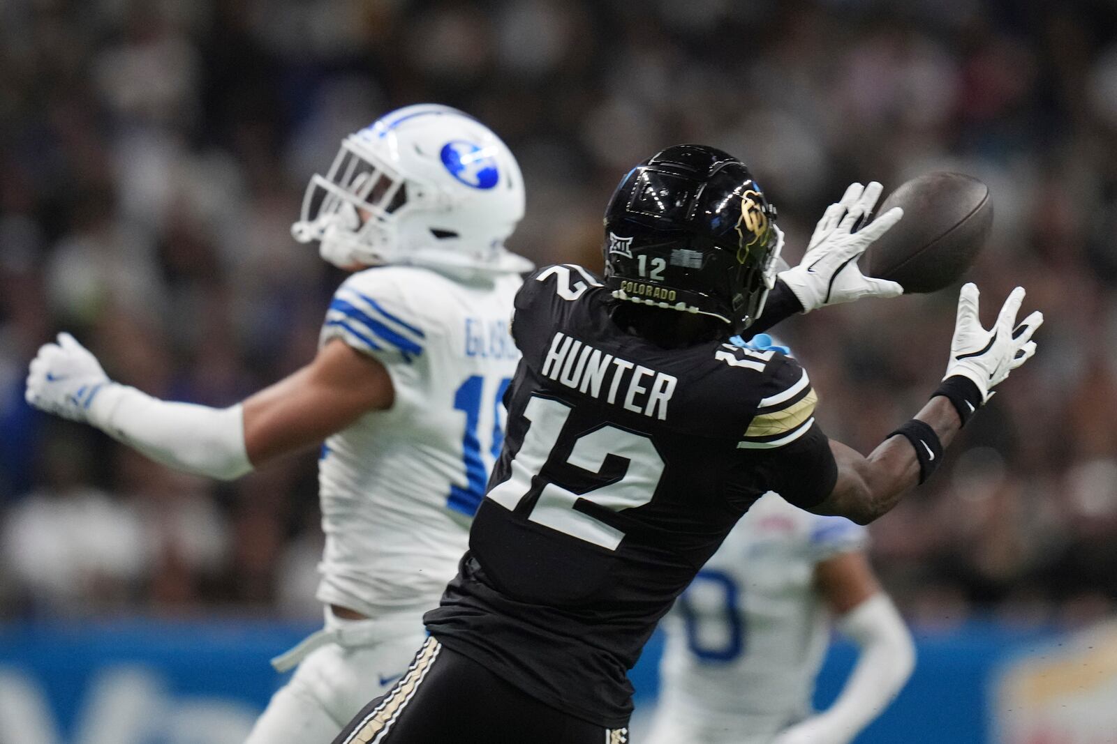 Colorado wide receiver Travis Hunter (12) makes a catch against BYU during the second half of the Alamo Bowl NCAA college football game, Saturday, Dec. 28, 2024, in San Antonio. (AP Photo/Eric Gay)