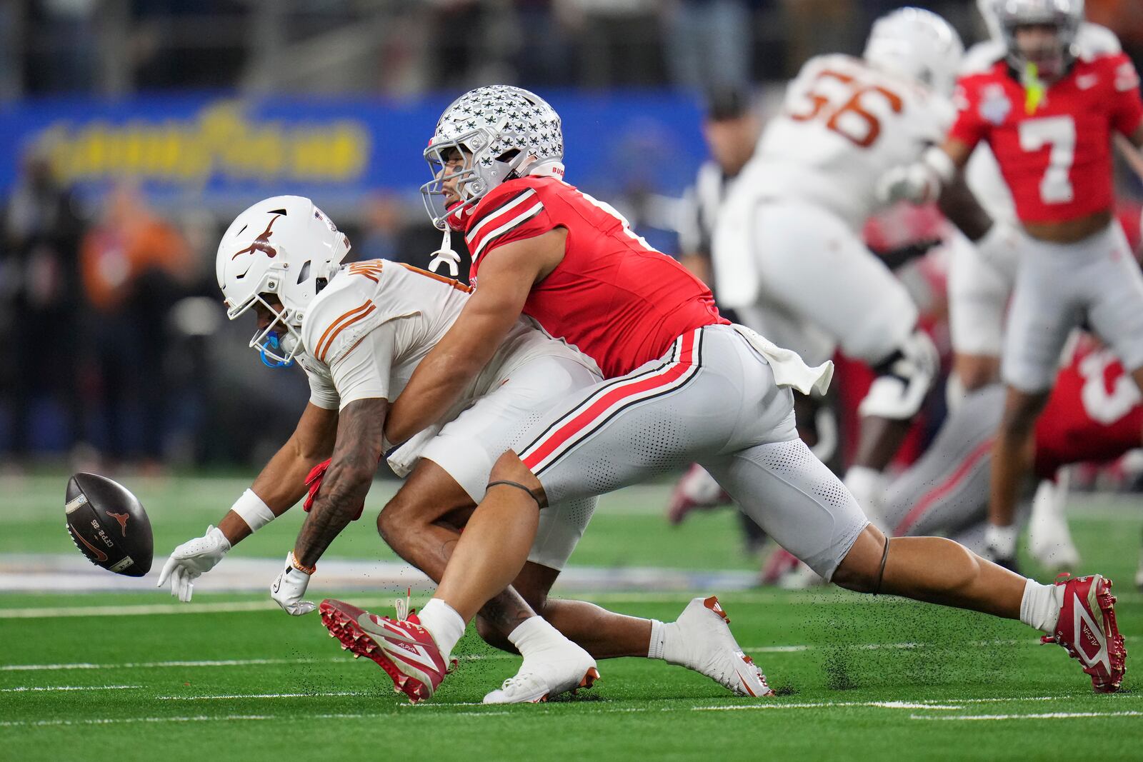 Texas wide receiver DeAndre Moore Jr., left, cannot catch a fourth down pass while being defended by Ohio State linebacker Cody Simon during the first half of the Cotton Bowl College Football Playoff semifinal game, Friday, Jan. 10, 2025, in Arlington, Texas. (AP Photo/Julio Cortez)