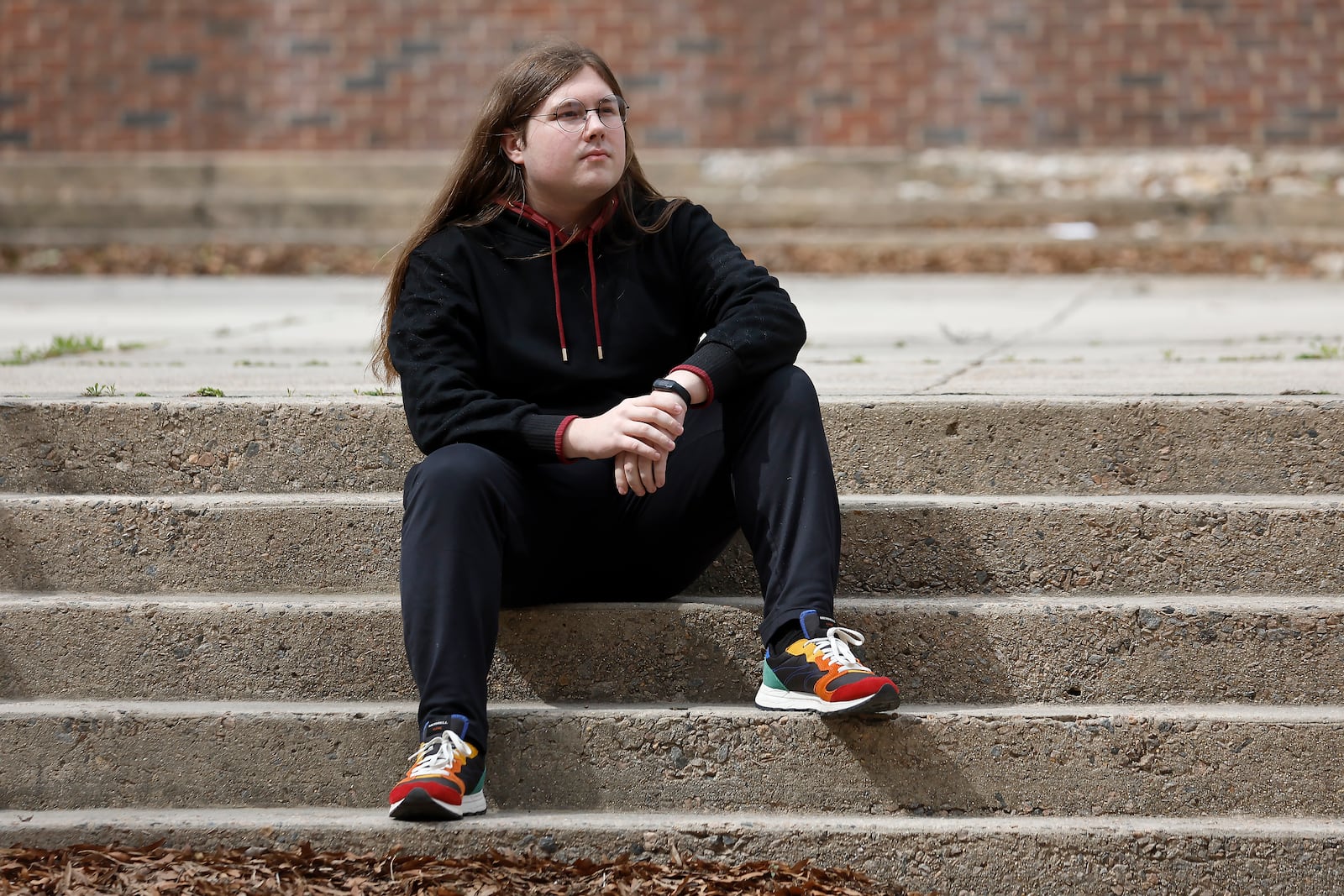 Glenn Thompson, a Durham School of the Arts graduate, poses in front of the school in Durham, N.C., Monday, March 10, 2025. (AP Photo/Karl DeBlaker)