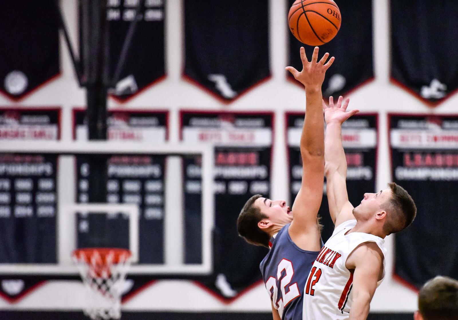 Carlisle's Justin Flor (22) and Franklin's Braden Hall jump for the opening tipoff Tuesday night at Darrell Hedric Gym in Franklin. NICK GRAHAM/STAFF