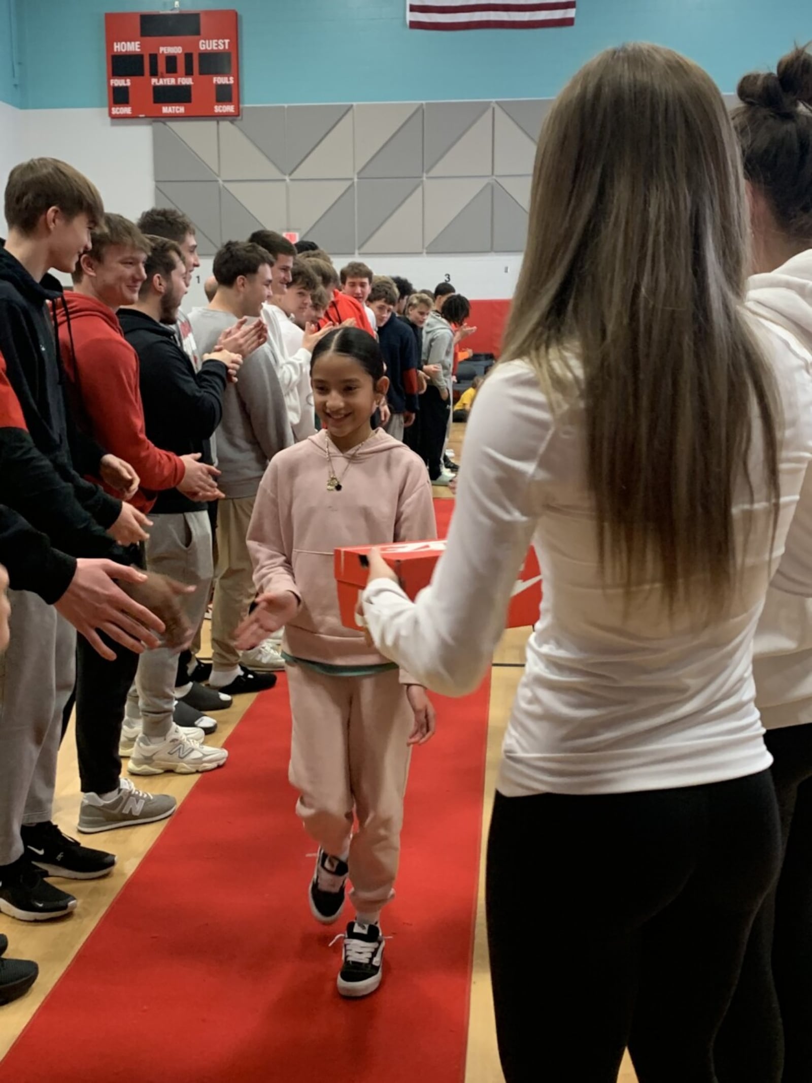 The 5th graders were escorted into the school’s gym last week and discovered they were the main attraction for a planned celebration by the older Fairfield students, school teachers and staffers who cheered on their red-carpet entrance before presenting them with new athletic shoes. (Provided)