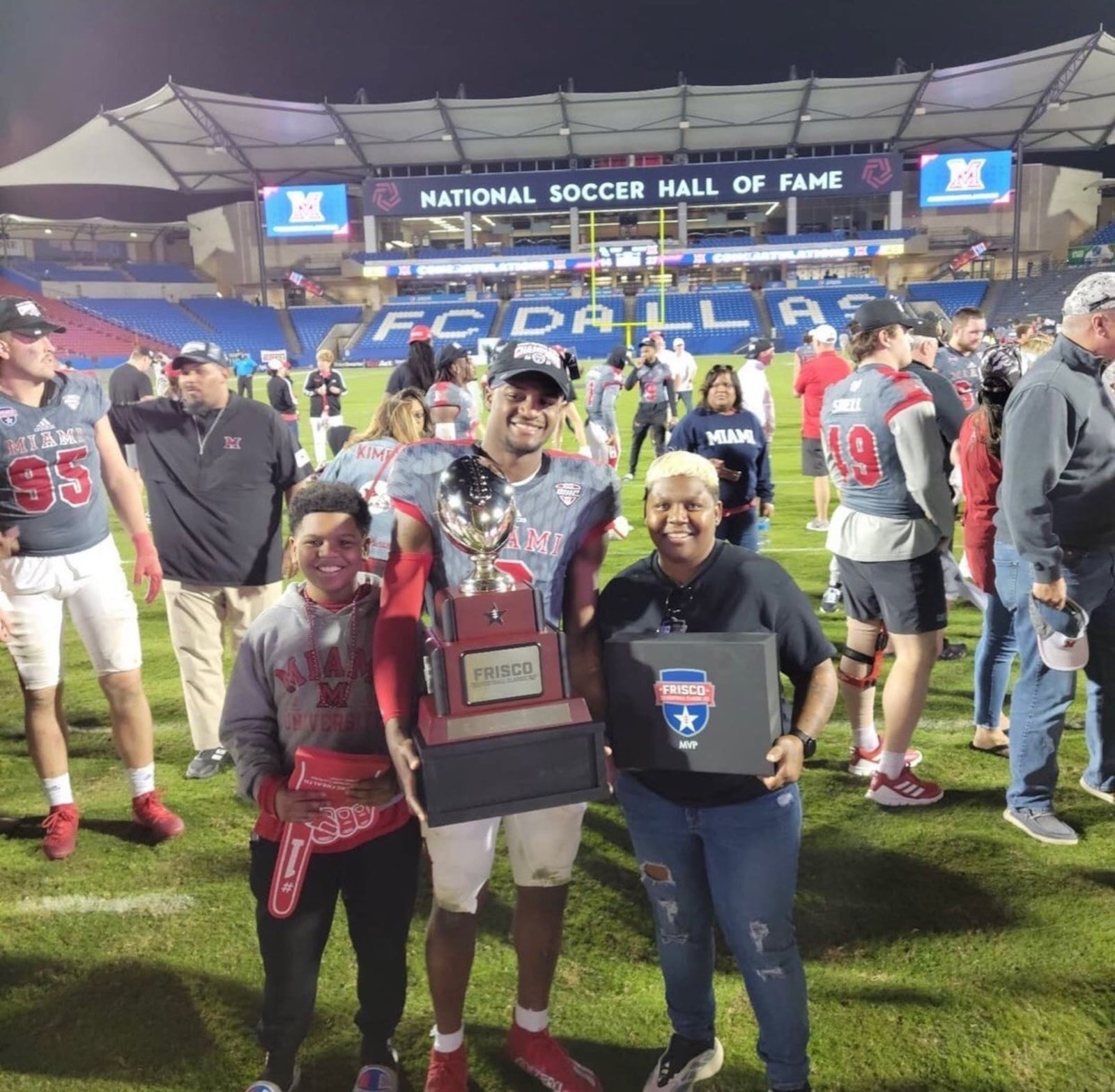 Jacquez Warren celebrates on the field with his aunt Lekendra Warren and her son Elijah Rogers Warren after Miami defeated North Texas, 27-14, in the Frisco Football Classic. Warren was named the Most Outstanding Defensive Player of the Game. CONTRIBUTED