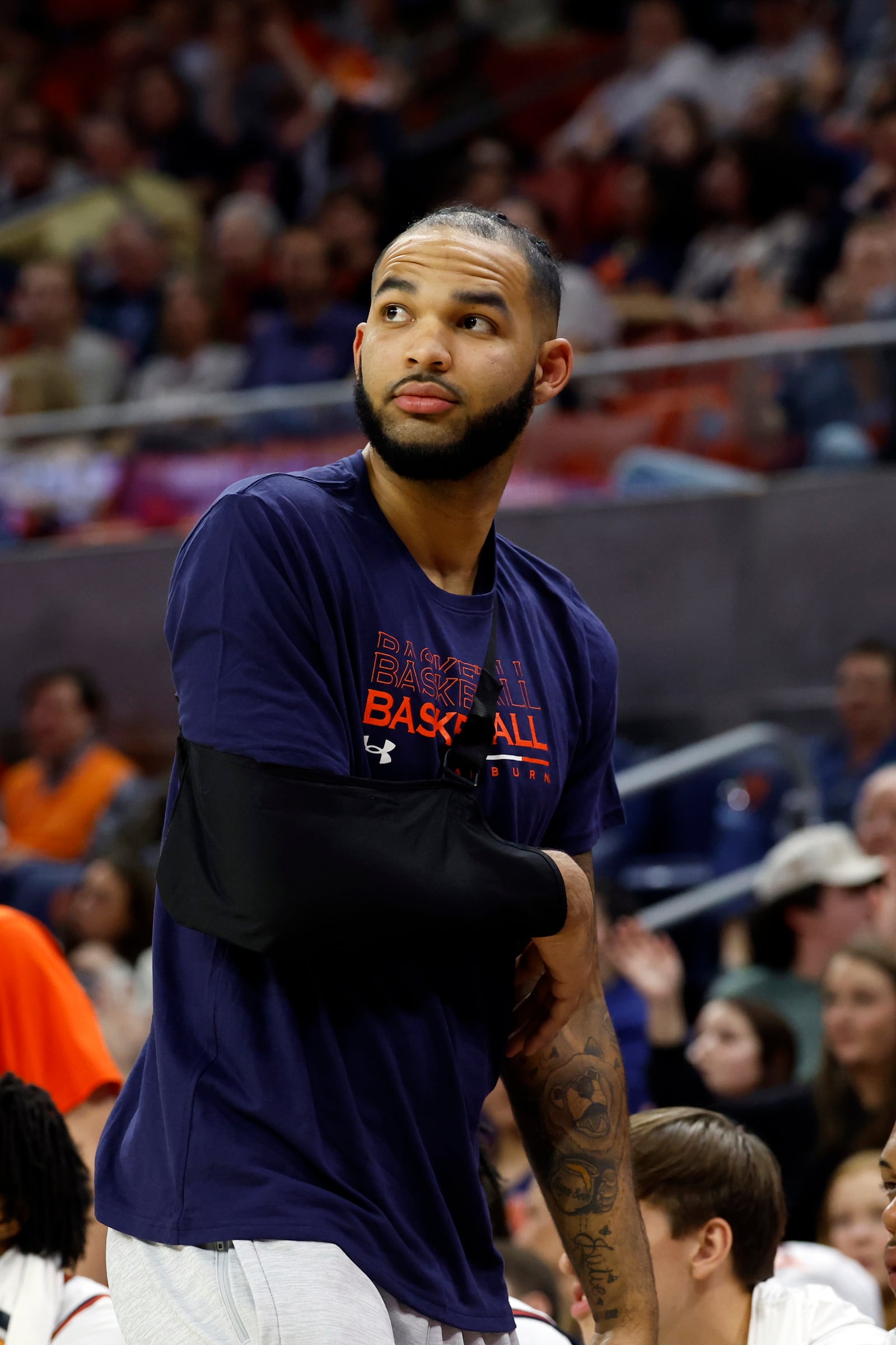 Auburn forward Johni Broome watches the game from the bench after sustaining an injury during the second half of an NCAA college basketball game against Georgia State, Tuesday, Dec. 17, 2024, in Auburn, Ala. (AP Photo/ Butch Dill)