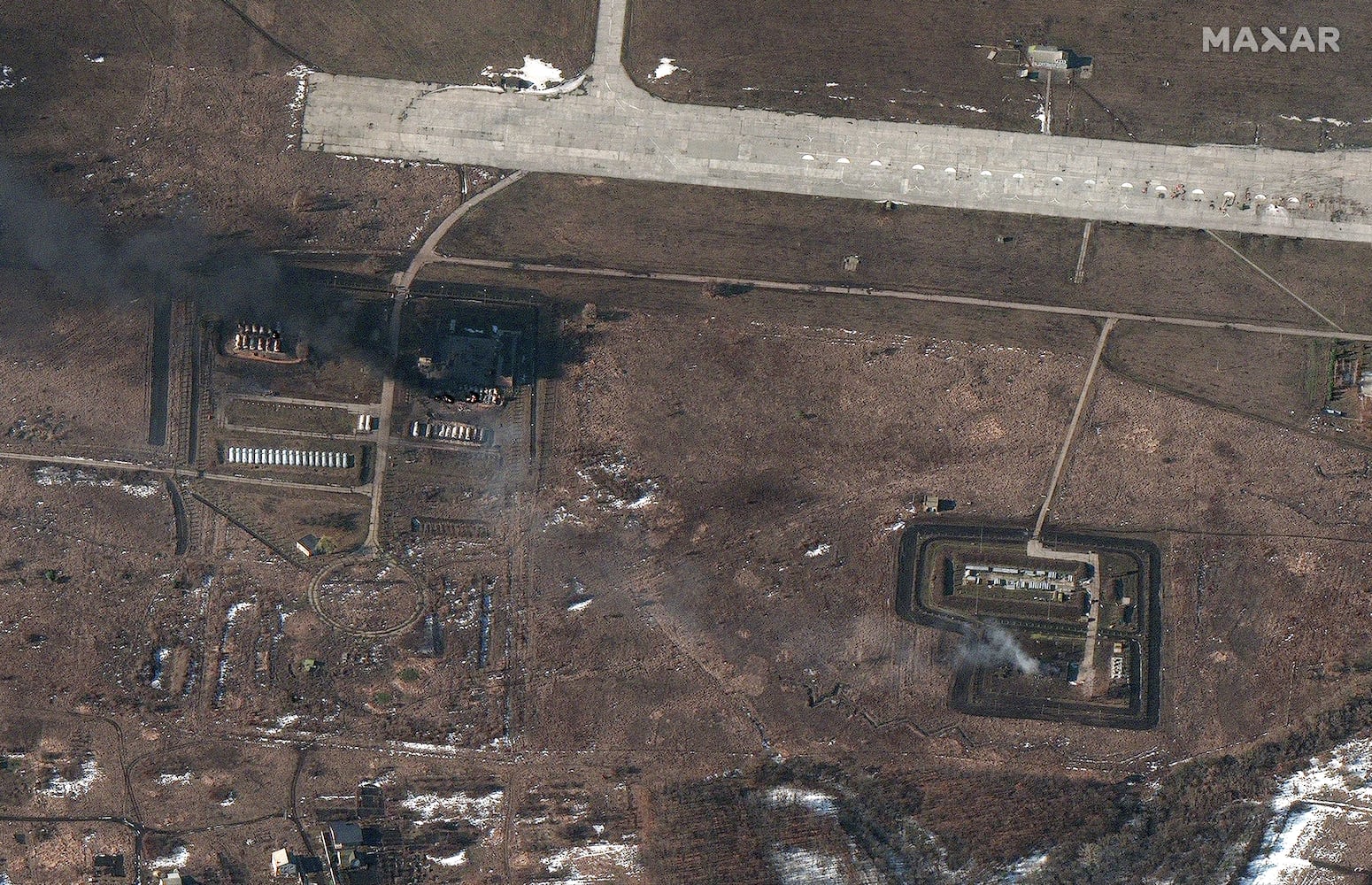 A satellite image provided by Maxar is said to show damage to fuel storage areas and other airport infrastructure at the Chuhuiv airfield in the eastern Ukrainian city of Chuhuiv, Thursday, Feb. 24, 2022. (Satellite image ©2022 Maxar Technologies via The