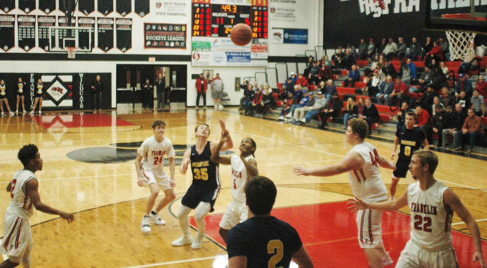 Franklin’s Savon O’Neal (5) and Monroe’s Caimanne Turner (35) are right in the middle of a rebound attempt Tuesday night at Darrell Hedric Gym in Franklin. The host Wildcats won 67-42. RICK CASSANO/STAFF