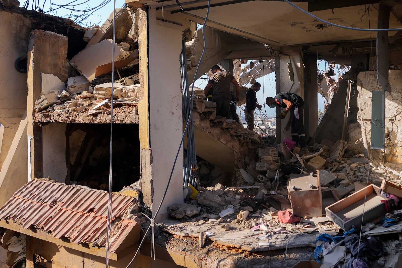 Civil defense workers inspect the rubble of a destroyed building hit in an Israeli airstrike on Tuesday night, in Barja, Lebanon, Wednesday, Nov. 6, 2024. (AP Photo/Hassan Ammar)