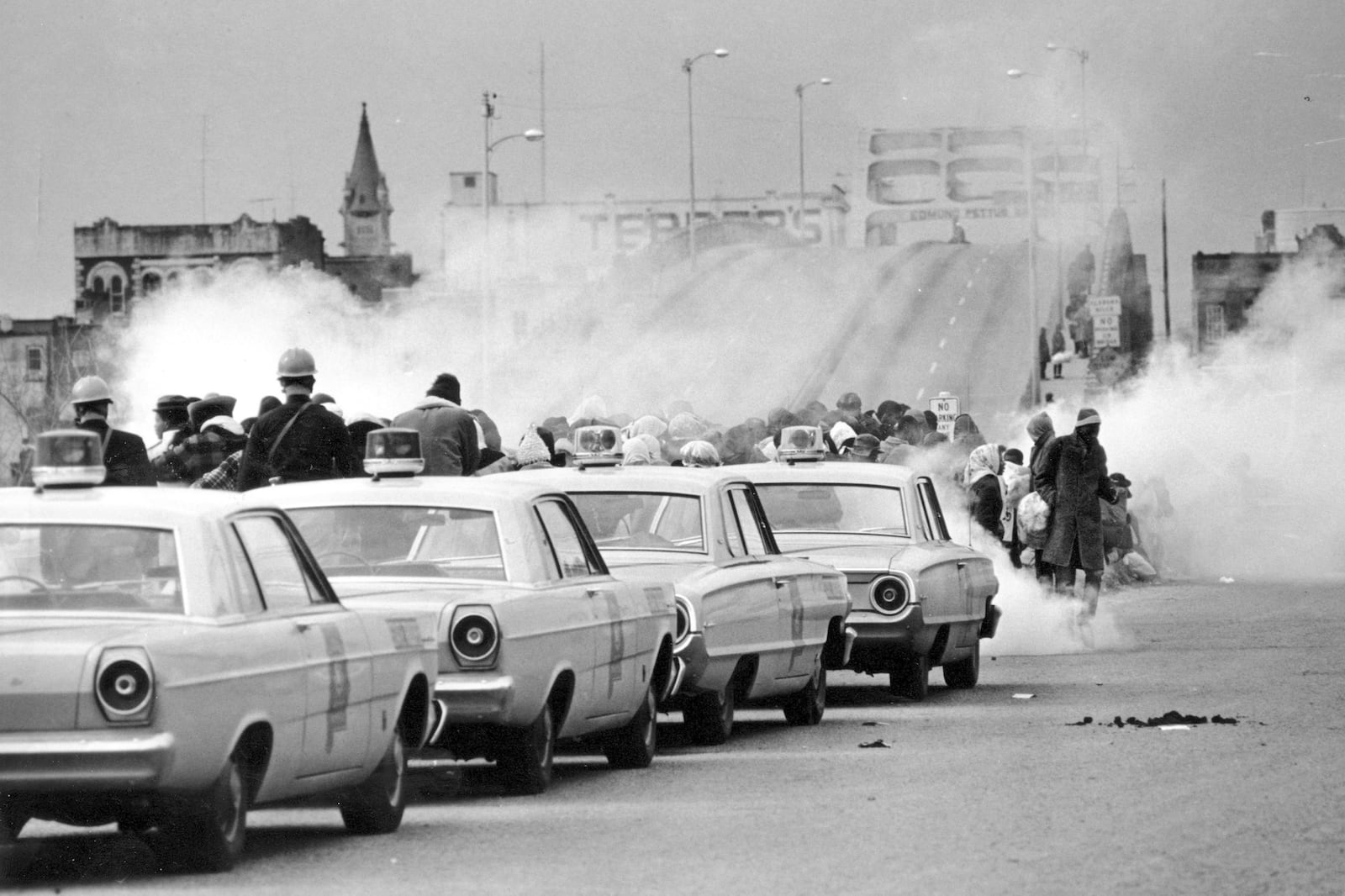 FILE - Clouds of tear gas fill the air as state troopers, ordered by Gov. George Wallace, break up a demonstration march in Selma, Ala., March 7, 1965, on what became known as "Bloody Sunday." (AP Photo, File)