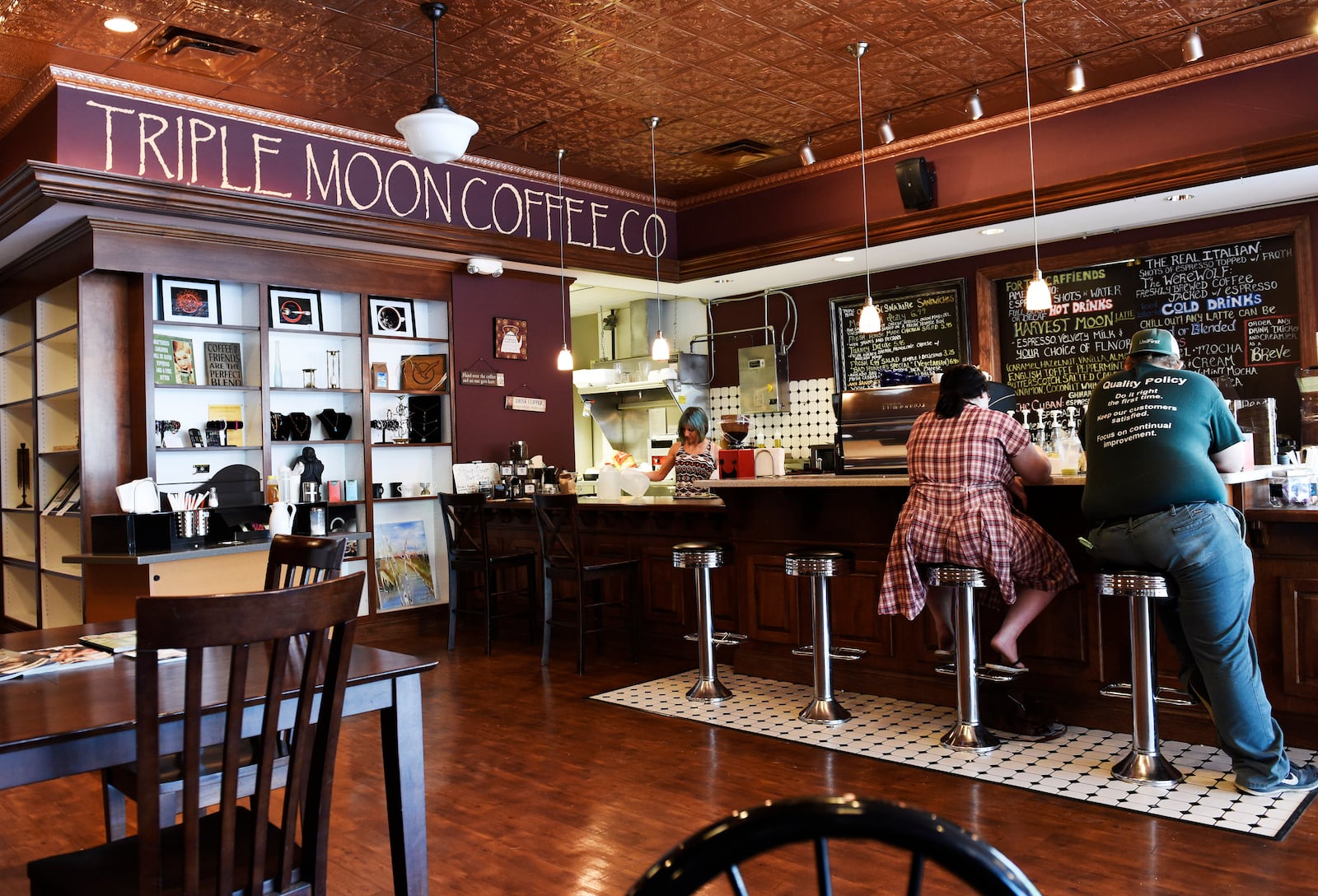 Customers sit at the counter at Triple Moon Coffee Company in Middletown. NICK GRAHAM/2015