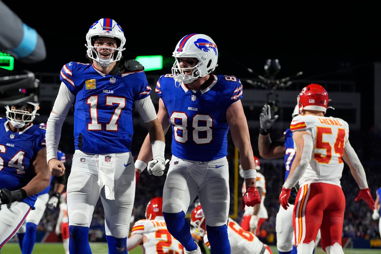 Buffalo Bills quarterback Josh Allen (17) is congratulated by teammate Dawson Knox (88) after scoring on a 26-yard run during the second half of an NFL football game against the Kansas City Chiefs Sunday, Nov. 17, 2024, in Orchard Park, N.Y. (AP Photo/Julia Demaree Nikhinson)