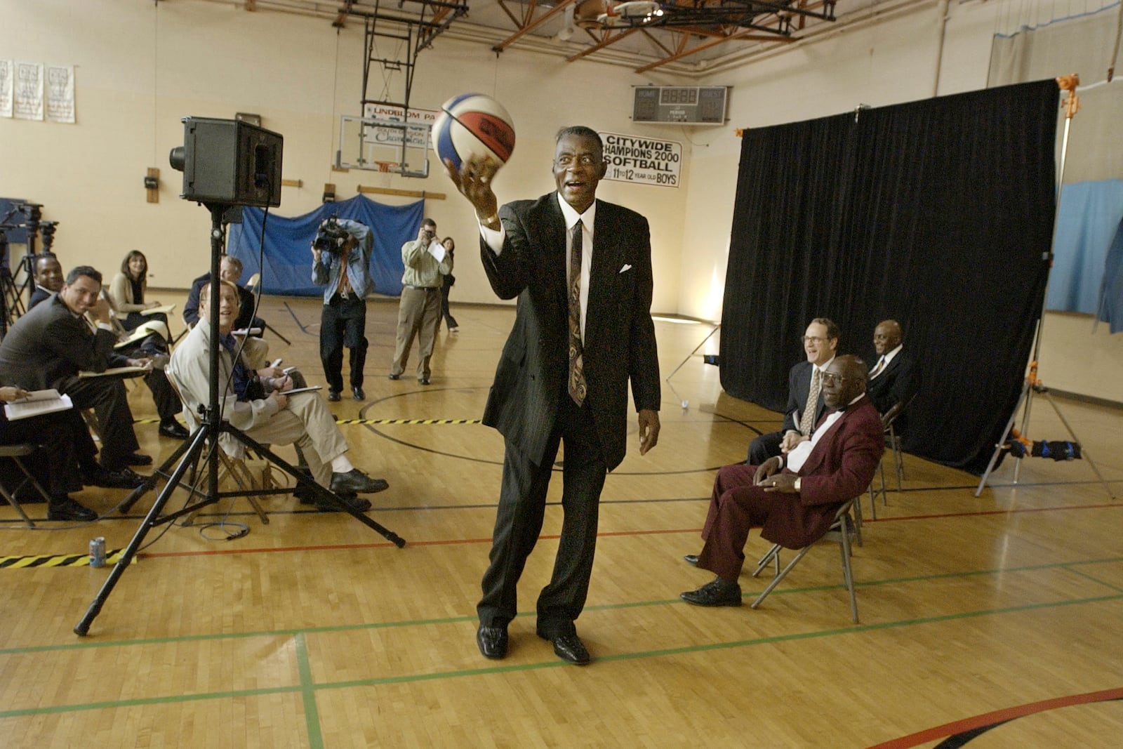 FILE - Former Chicago Bulls player and director of community affairs for the team, Bob Love, shows media members that he hasn't lost his touch with the ball after announcing his candidacy for Alderman in the cities 15th ward, Sept. 25, 2002, in Chicago. (AP Photo/M. Spencer Green, File)