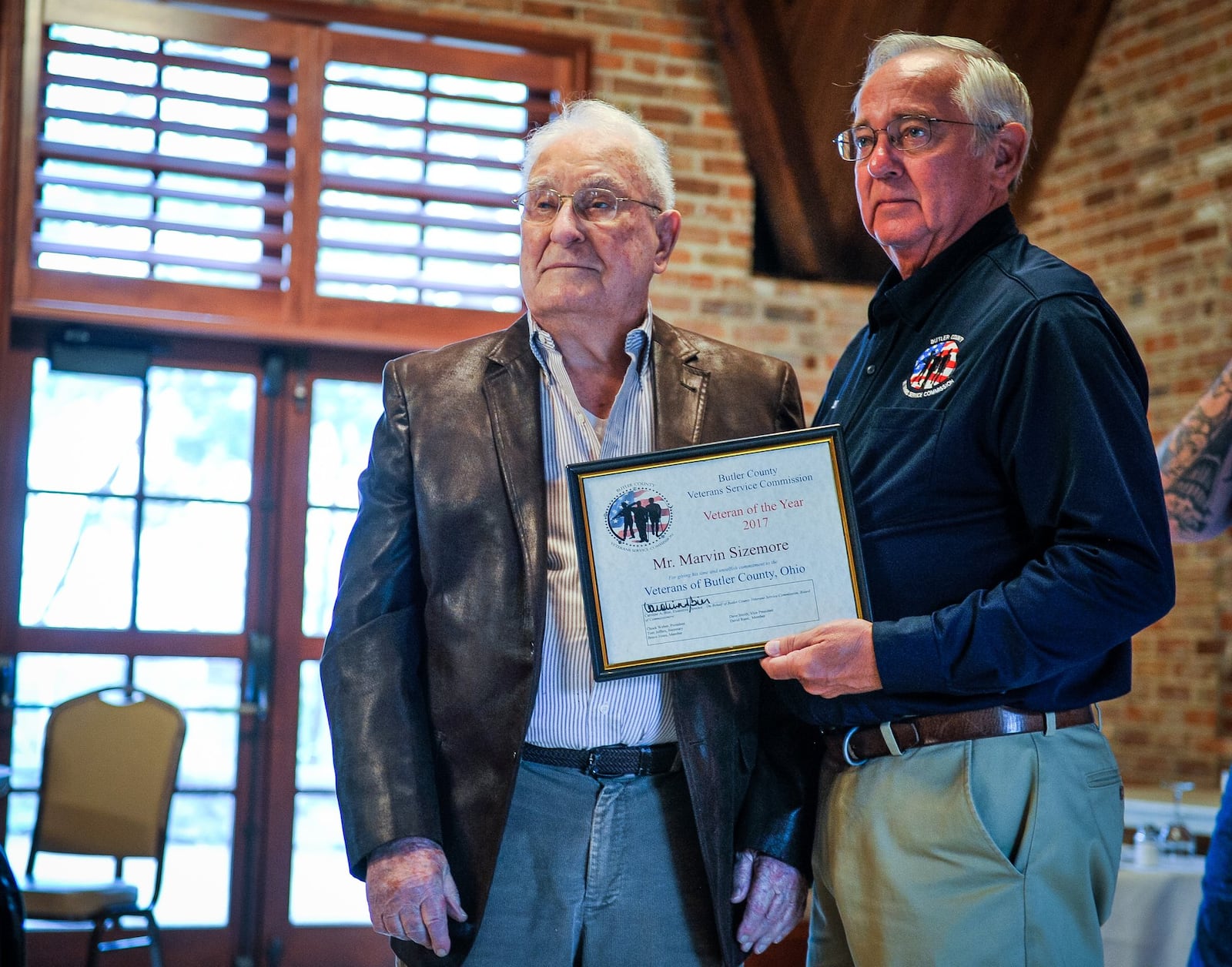 Marvin Sizemore, left, one of two Veteran of the Year recipients at the annual Butler County Veteran’s Day program, is presented his award by Tom Jeffers from Butler County Veterans Service Commission Monday, Nov. 12.