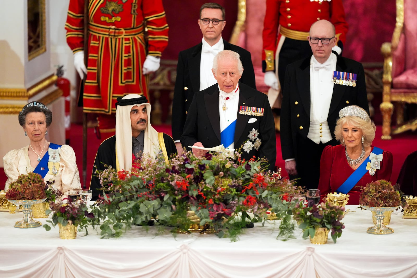 Britain's King Charles III, centre, and Queen Camilla, right, with the Emir of Qatar Sheikh Tamim bin Hamad Al Thani, second left, and Britain's Princess Anne, left, during a State Banquet at Buckingham Palace, in London, Tuesday, Dec. 3, 2024, during the state visit to the U.K. of the Emir of Qatar. (Jordan Pettitt/Pool Photo via AP)