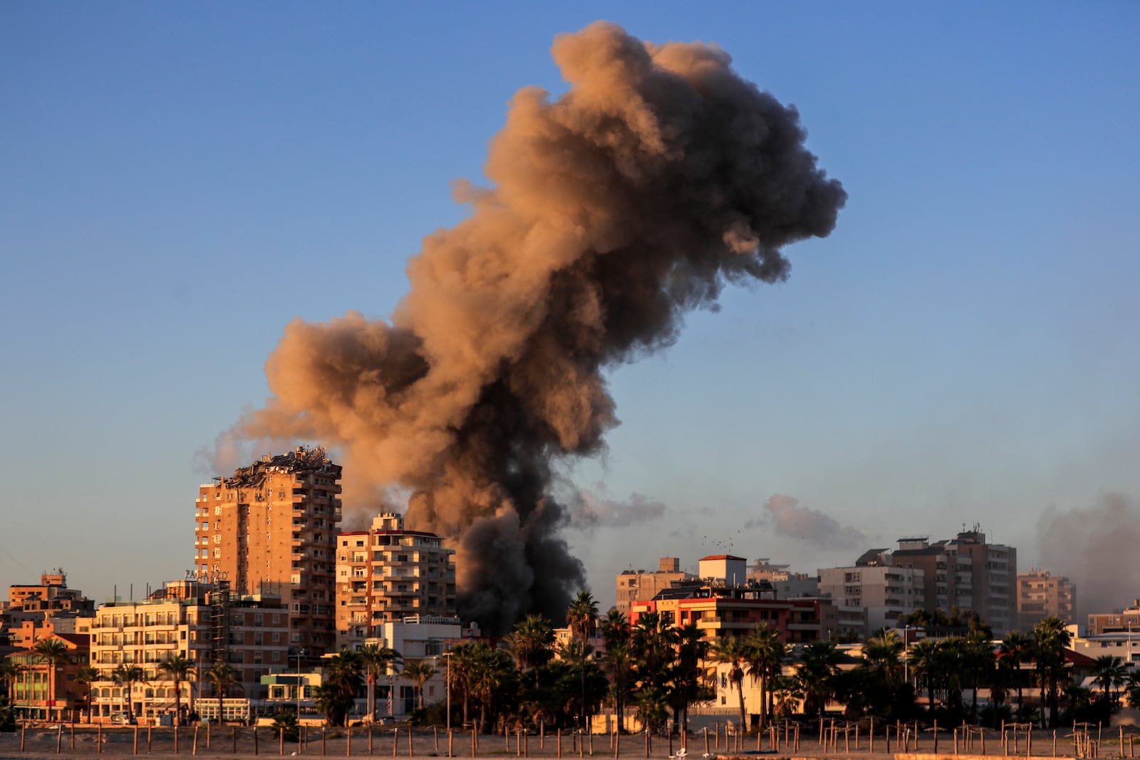 Smoke rises from a building hit in an Israeli airstrike in Tyre, southern Lebanon, Saturday, Nov. 16, 2024. (AP Photo/Mohammed Zaatari)