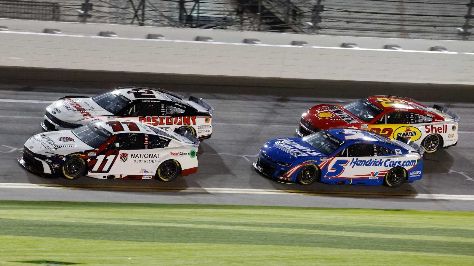 Denny Hamlin (11), Austin Cindric (2), Kyle Larson (5) and Joey Logano (22) head to turn 1 during early laps of the second of two NASCAR Daytona 500 qualifying auto races at Daytona International Speedway, Thursday, Feb. 13, 2025, in Daytona Beach, Fla. (AP Photo/Terry Renna)